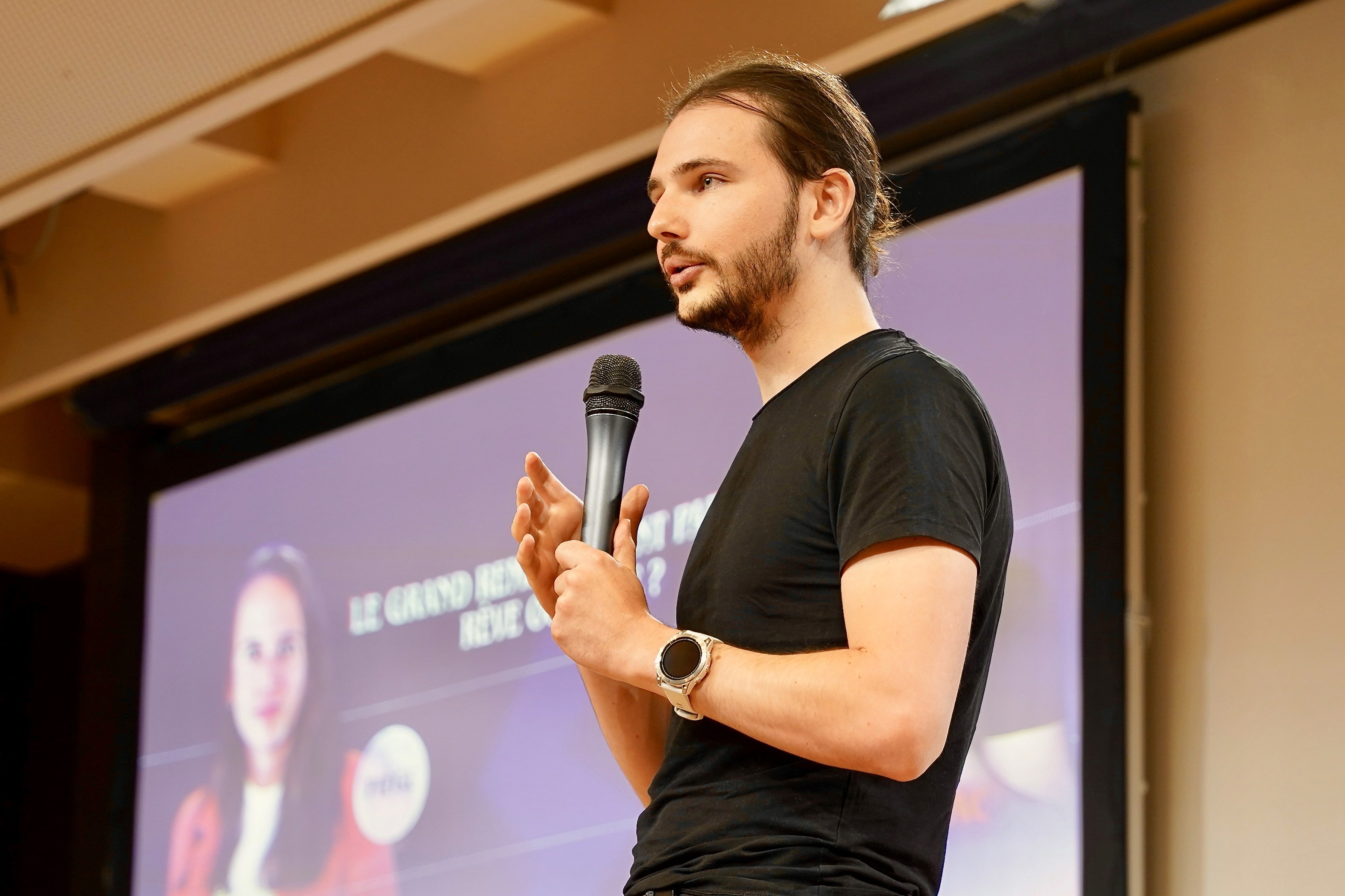 A film director sits in a chair facing a bustling, warmly lit night market scene. A camera setup is nearby, capturing the energetic atmosphere.