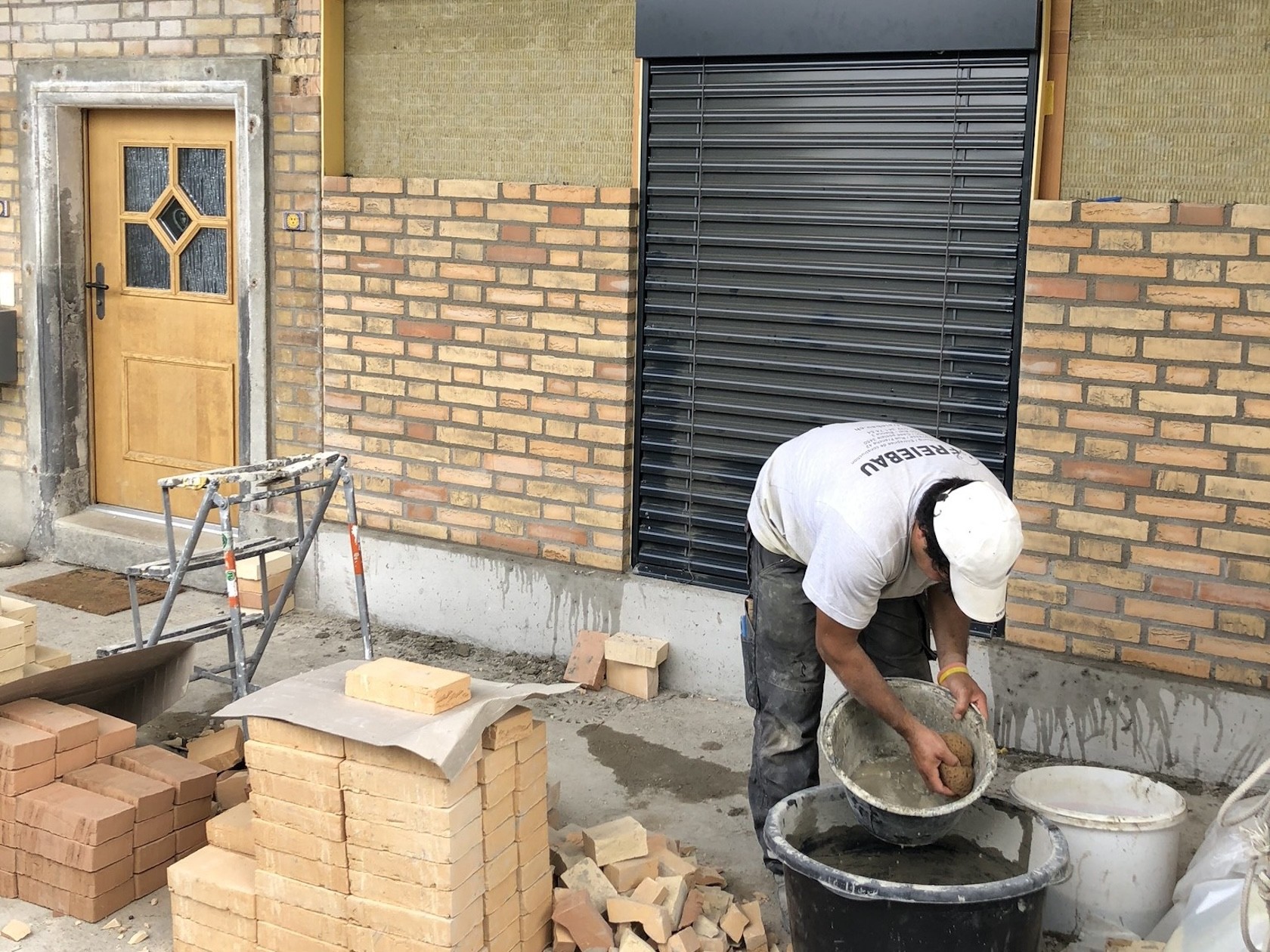 Umgebauter Garagenbereich mit Sichtmauerwerk im Stil des Bestands.