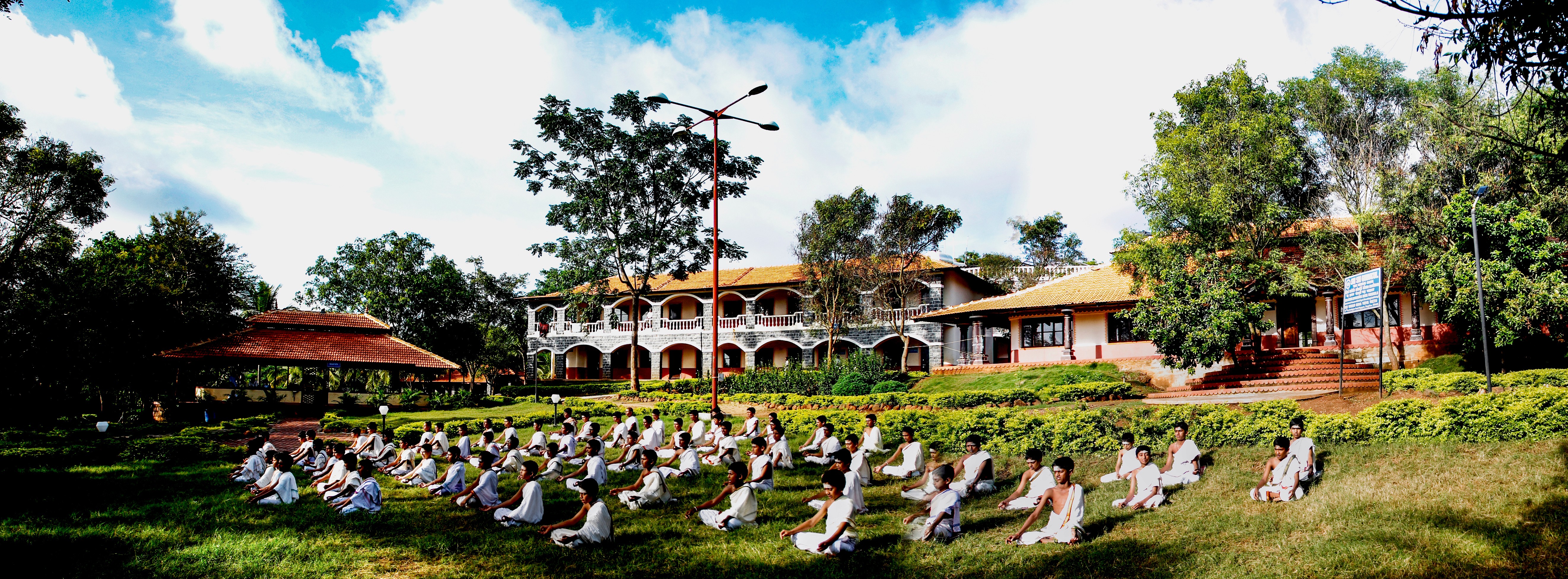 Aerial view of a winding road cutting through rocky terrain with patches of grass.