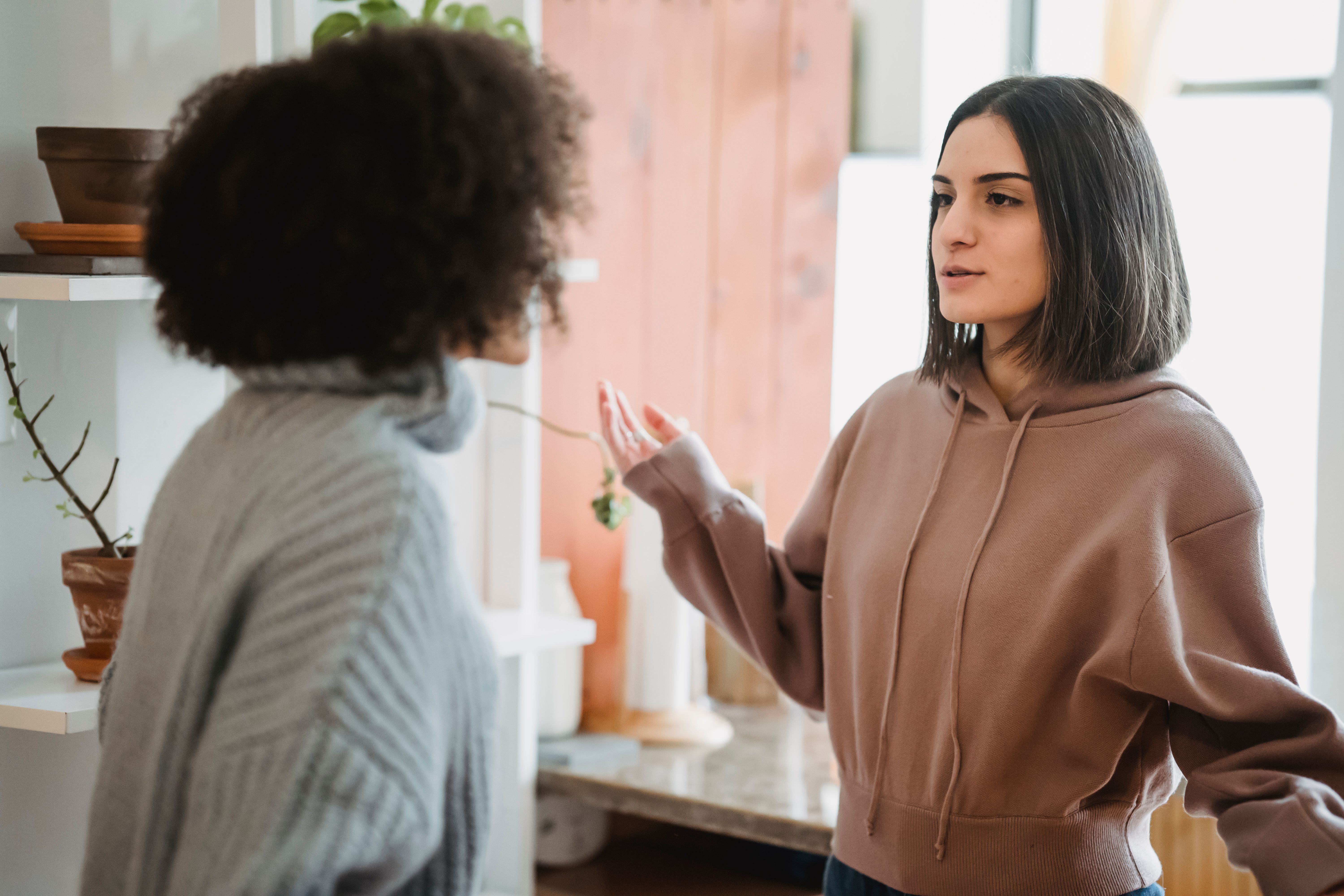 Two women stood up talking