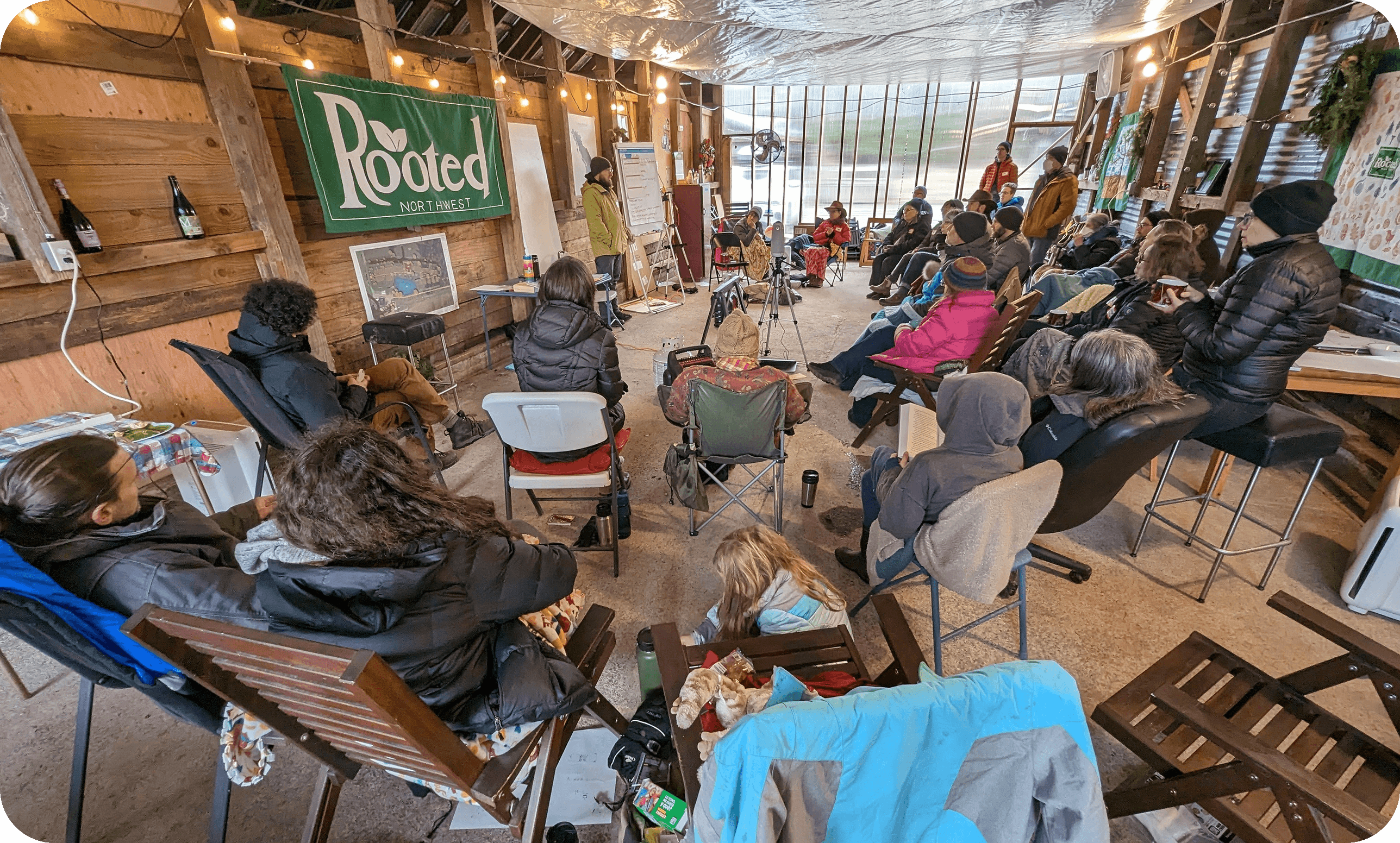 A group of community members gathered together outdoors at Rooted Northwest.