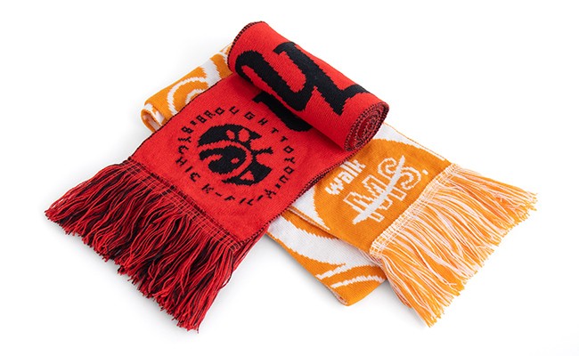 2 stadium jerseys one is red and one is orange on a white background.