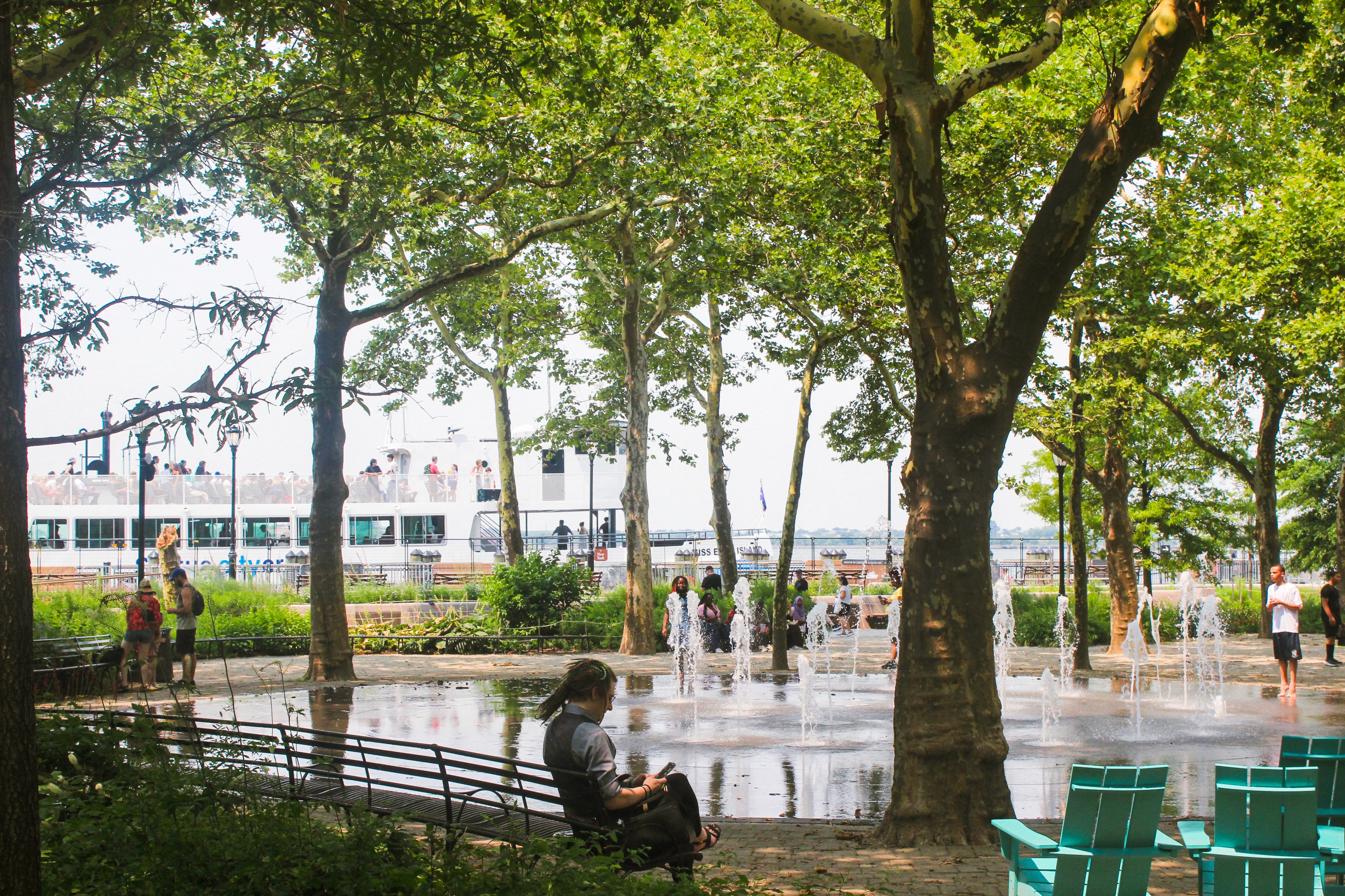Trees, a fountain, and people in Battery Park
