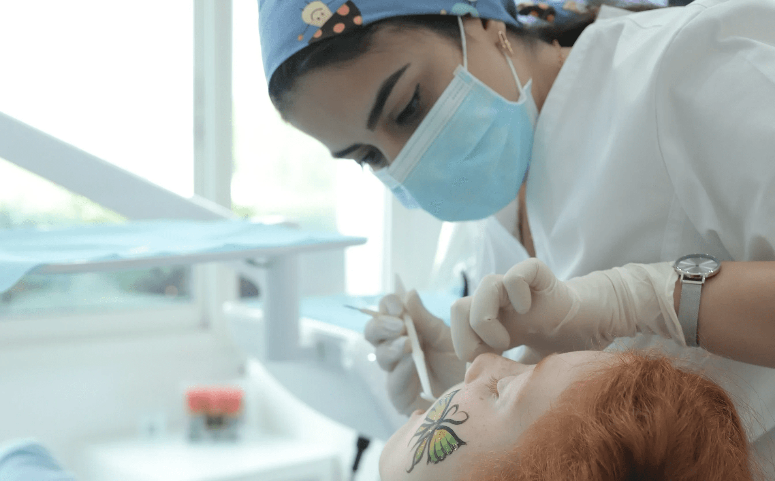 A paediatric dentist performing a regular checkup on a child to detect cavities in kids early, by the Invisalign Center