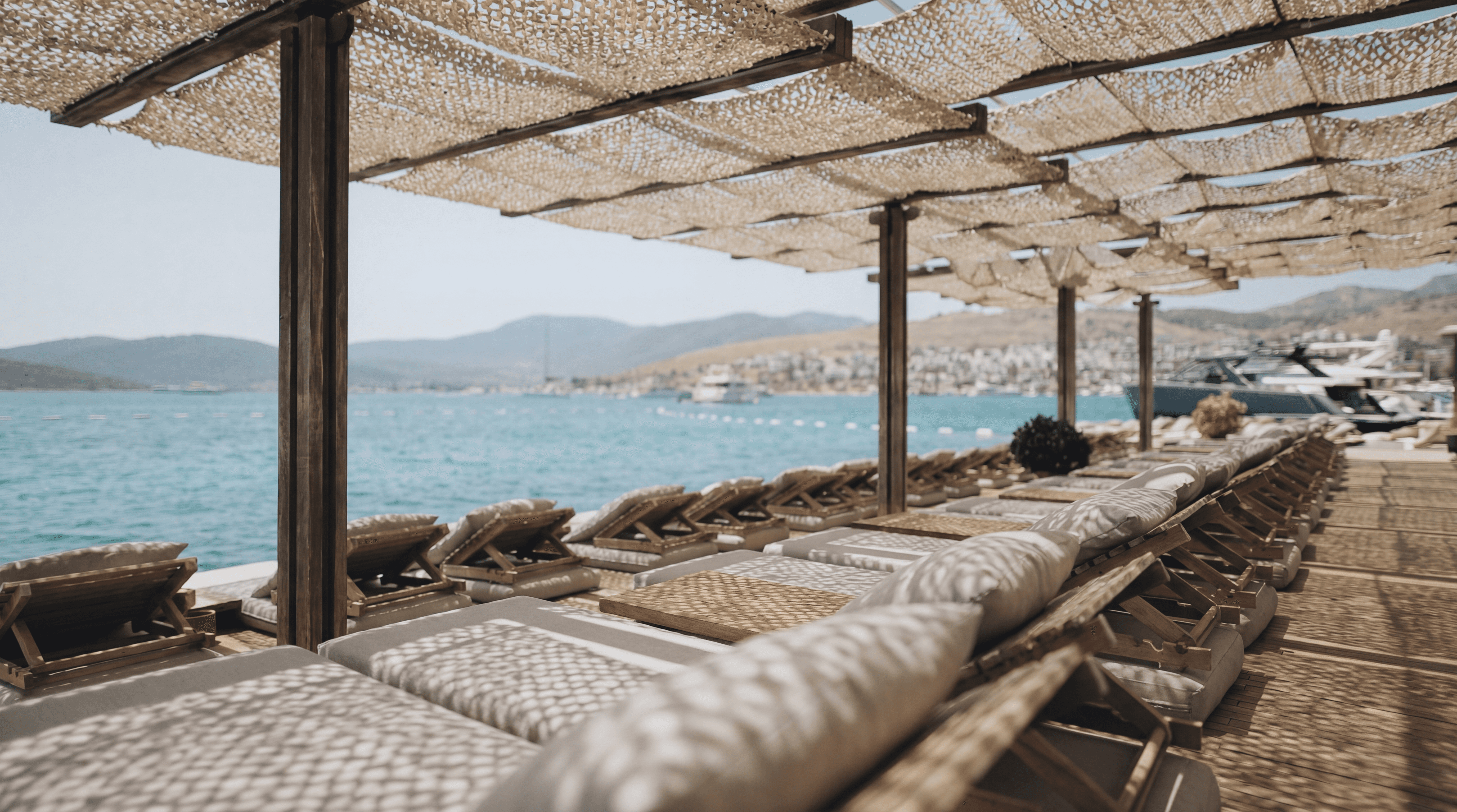 Maçakızı Beach Club sunbeds Türkbükü Bodrum waterfront luxury beach club shaded deck Aegean sea