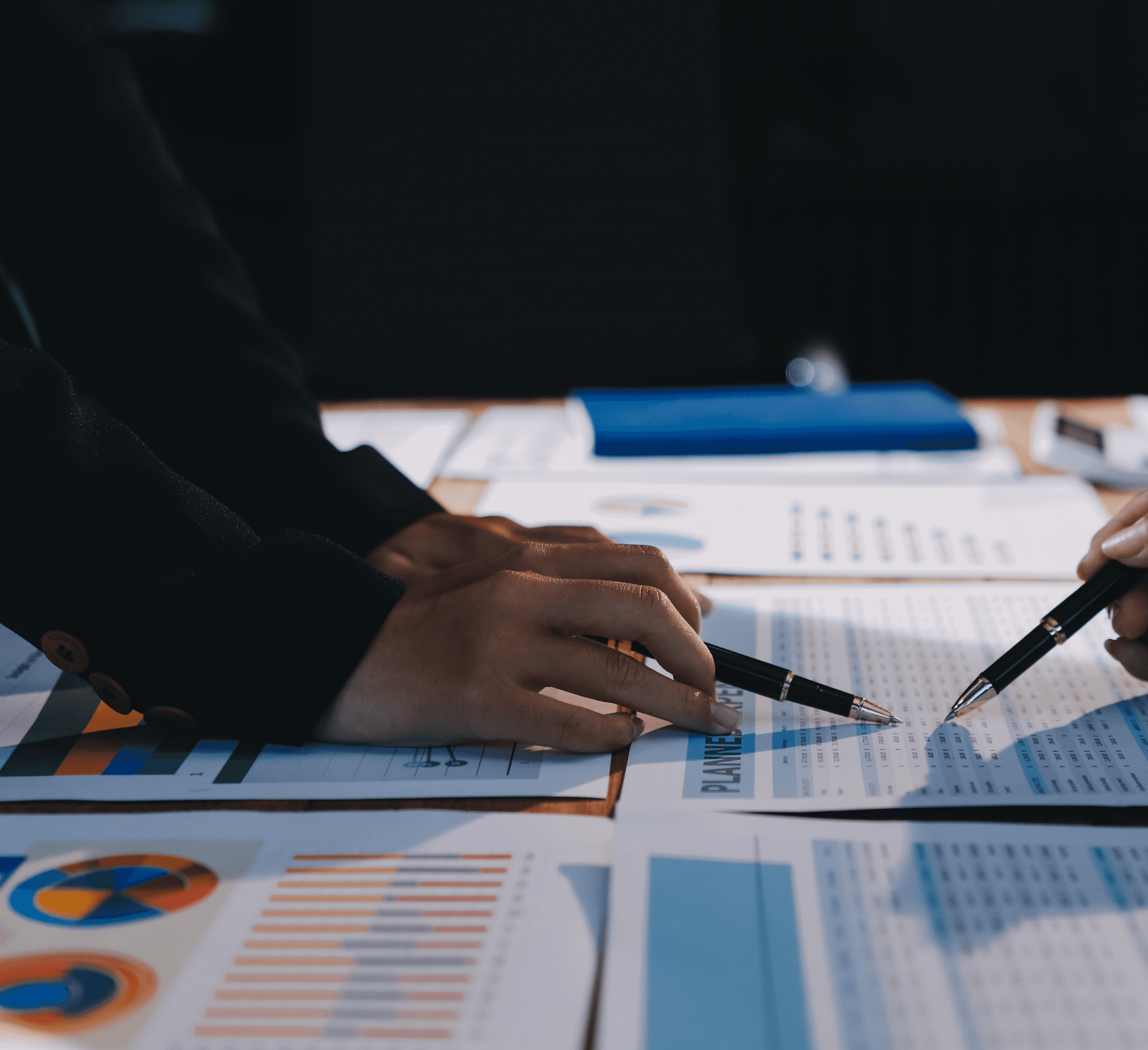 Woman in red outfit poses by a red telephone booth.