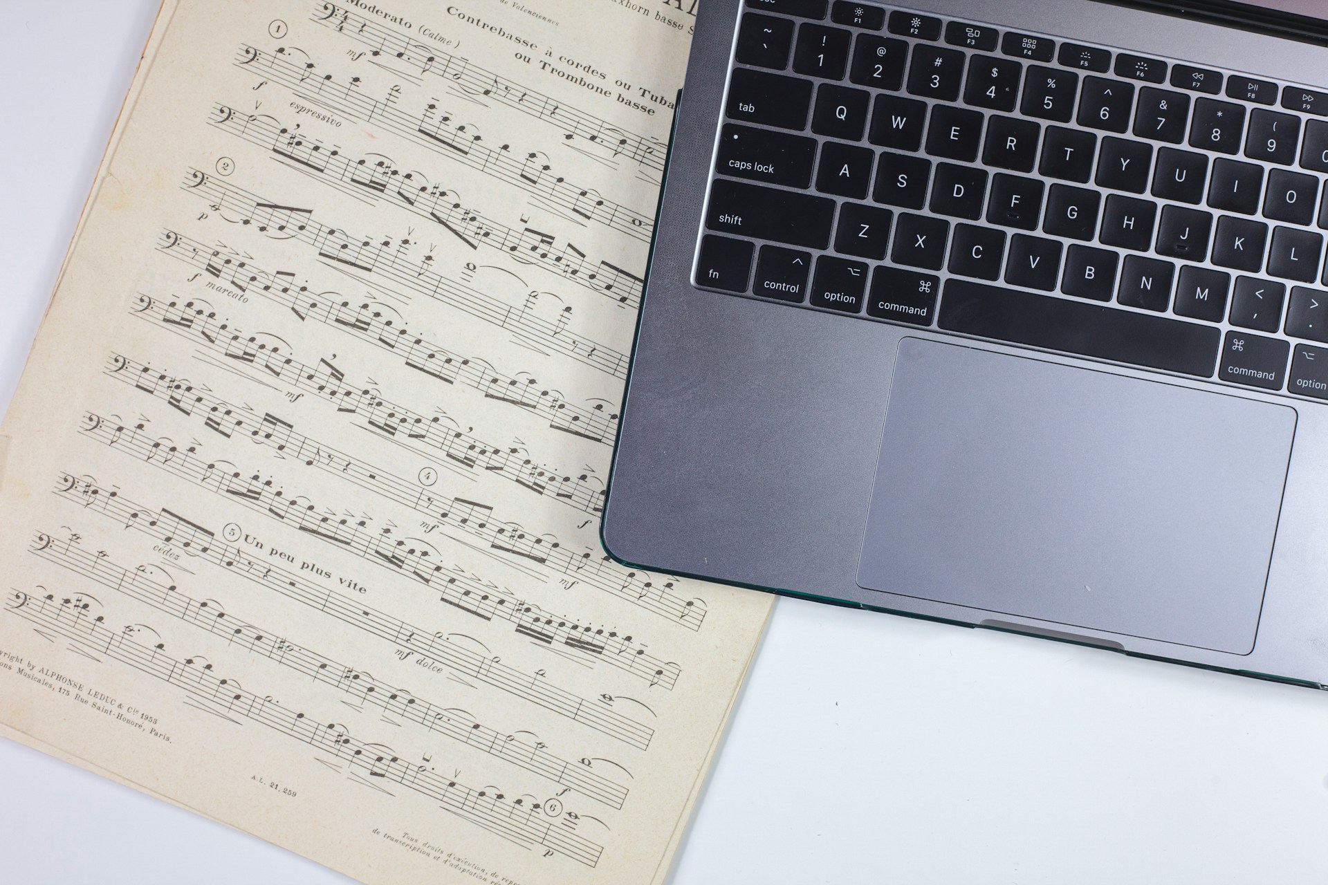 laptop and music sheet - How to Make Instrumental Music