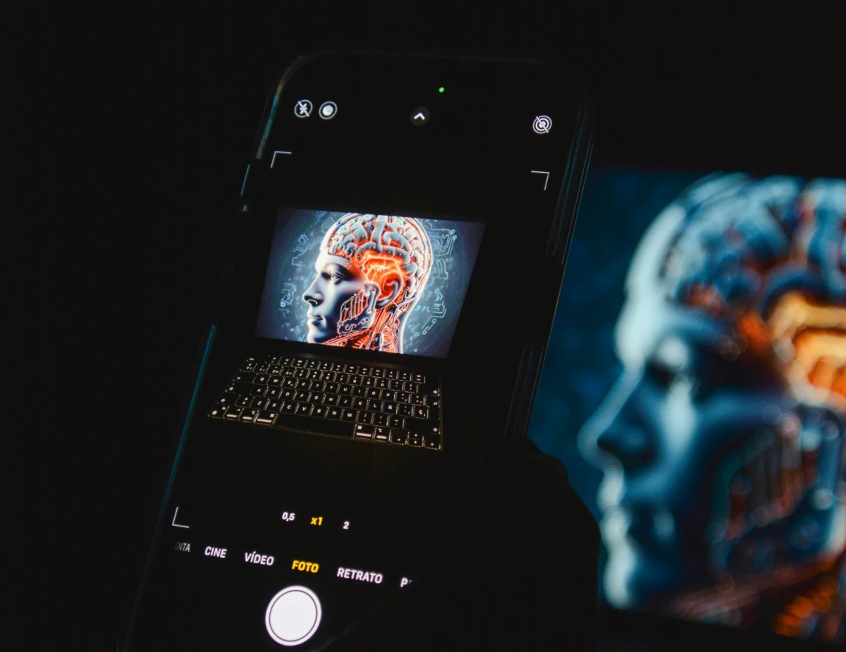 a cell phone sitting on top of a laptop computer