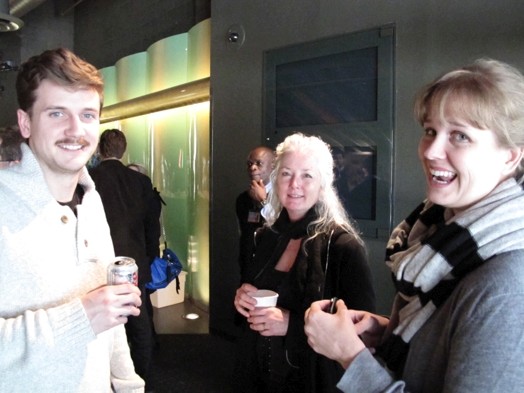 a photo of two women and a man talking