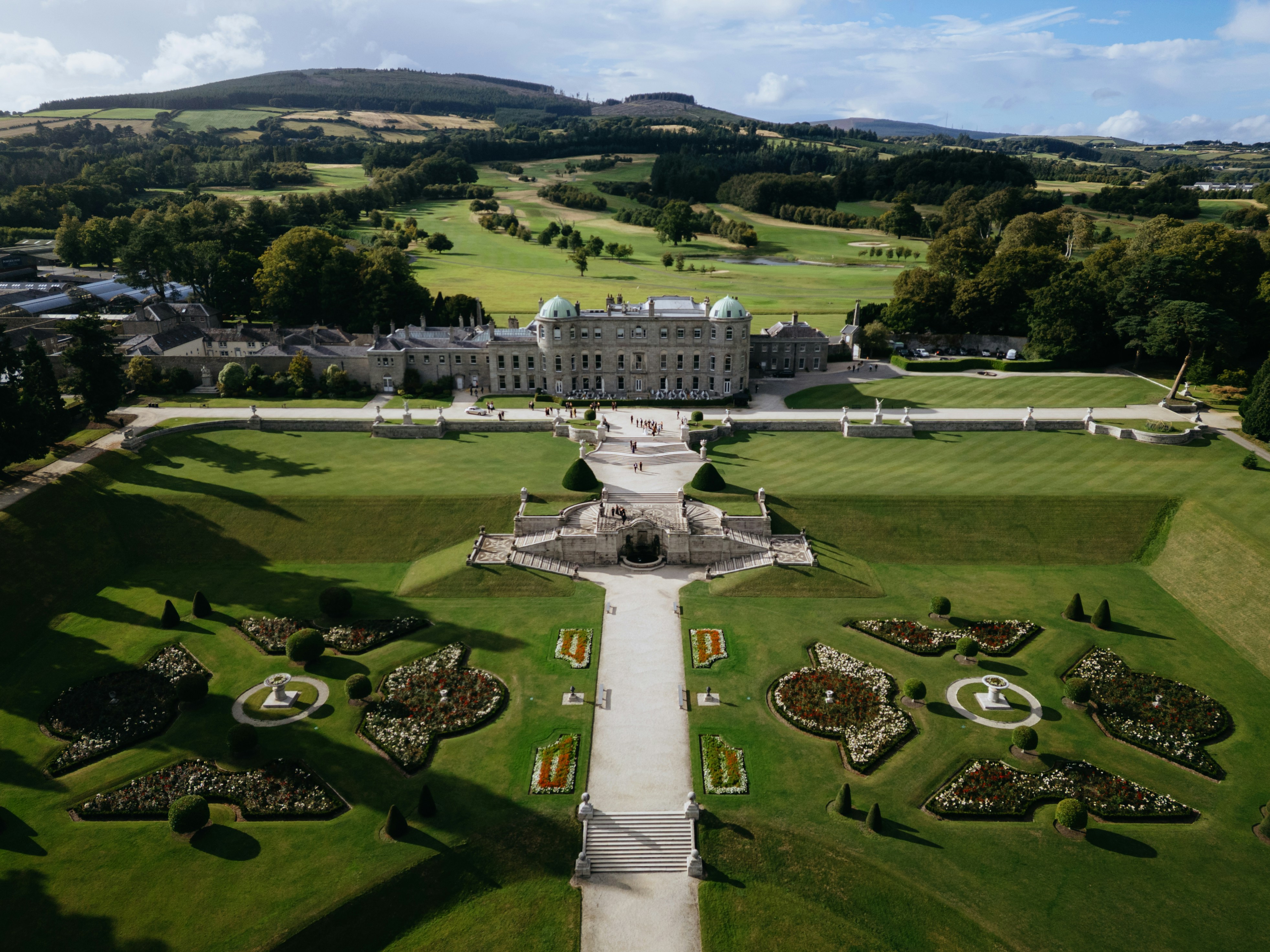 A drone shot of a hotel from above, showcasing the garden area.A drone shot of a hotel from above, showcasing the garden area.