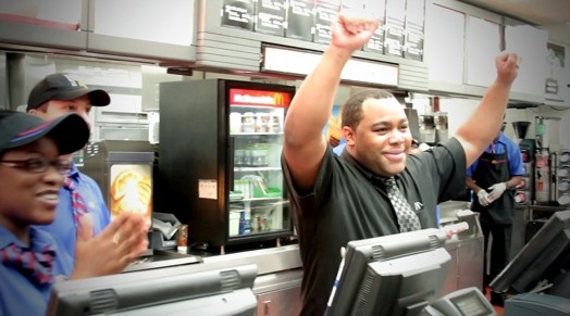 image of a man with his hands up in the air in a restaurant