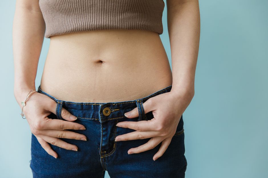 Woman discussing bloating and digestive symptoms with a doctor in a clinical consultation about IBS and SIBO