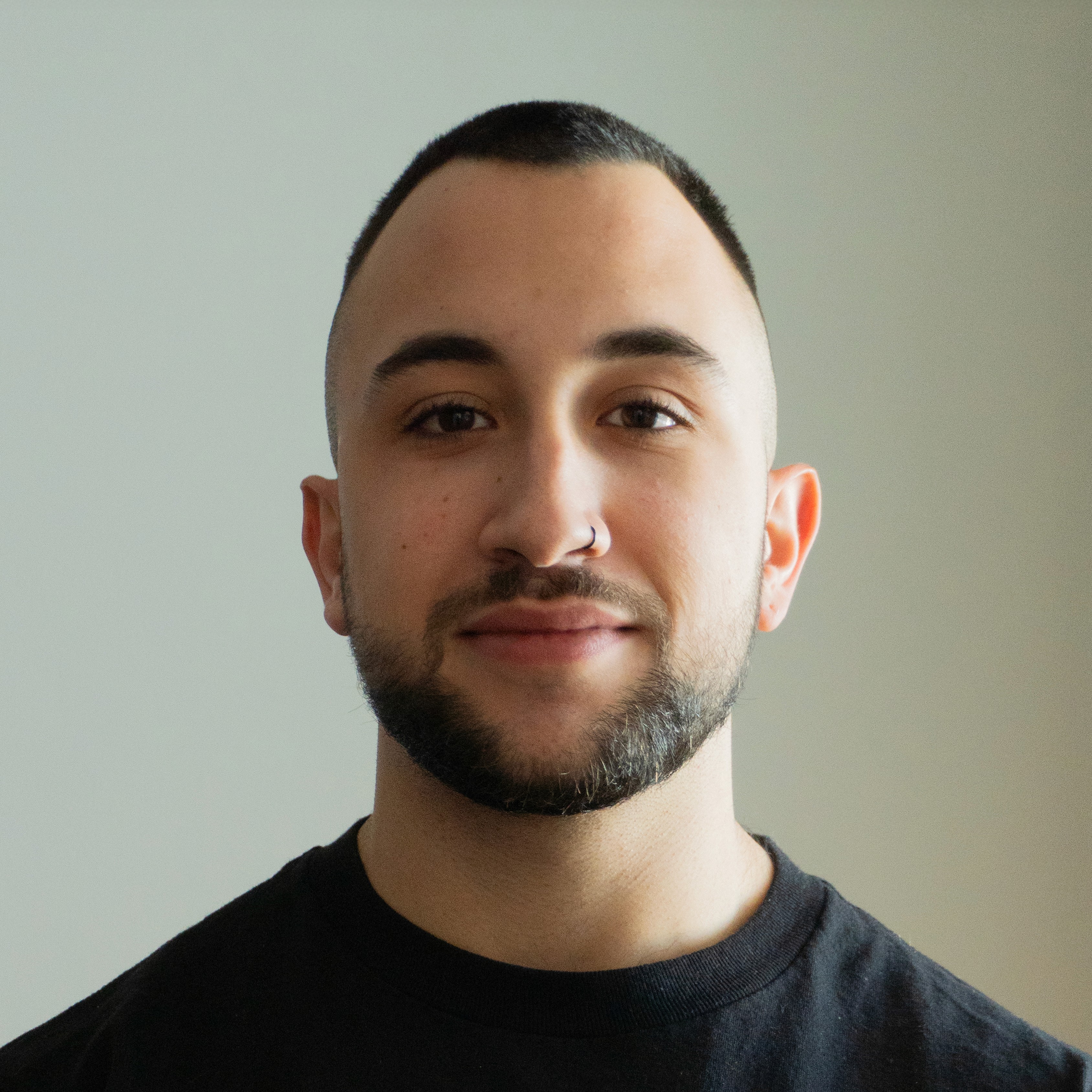 A smiling woman writing on a piece of paper in her home