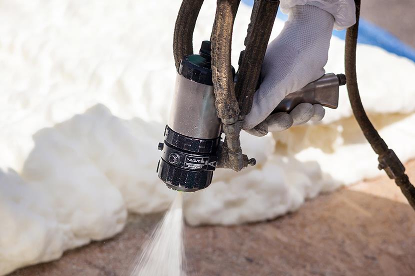 a man in a yellow shirt is working on a roof