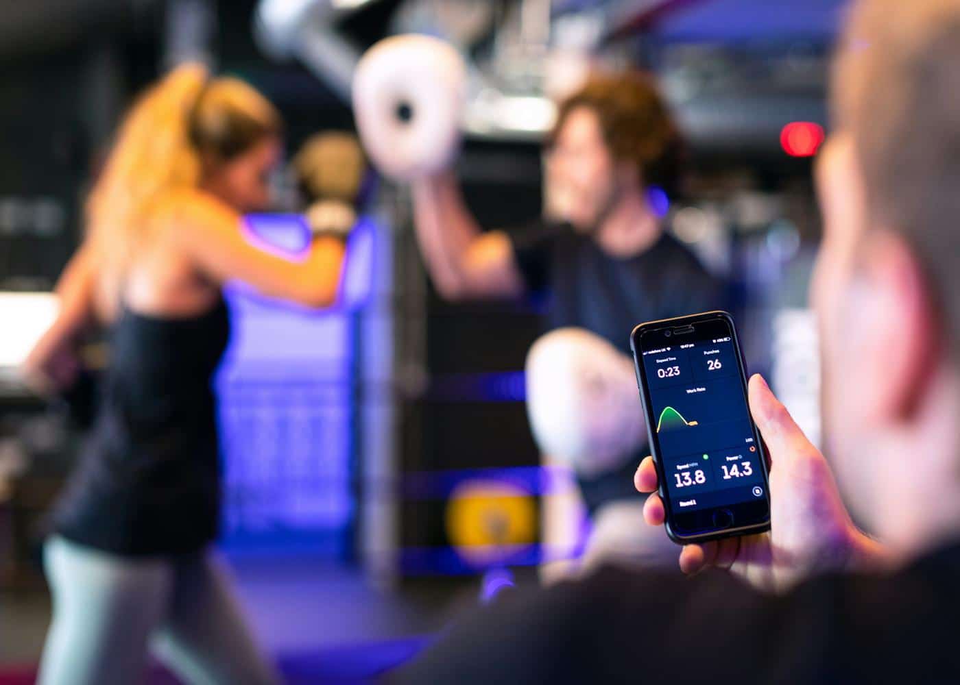Man using an app to monitor health at the gym