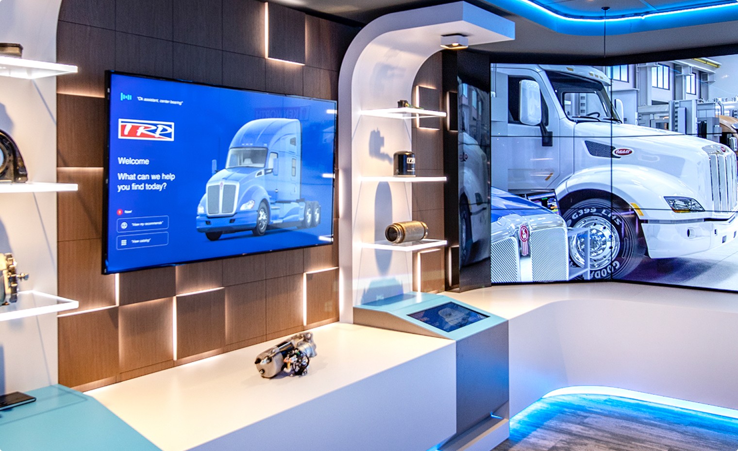 The PACCAR experience kiosk featuring a floor to ceiling video screen showing Peterbuilt and Kenworth trucks