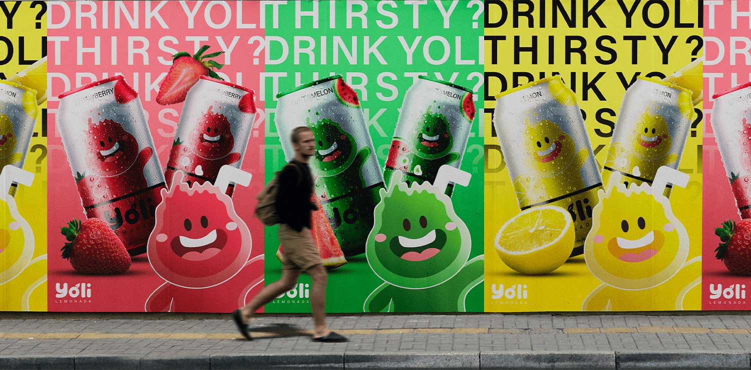 A vibrant street billboard featuring colorful Yoli lemonade cans in multiple flavors with playful character illustrations.