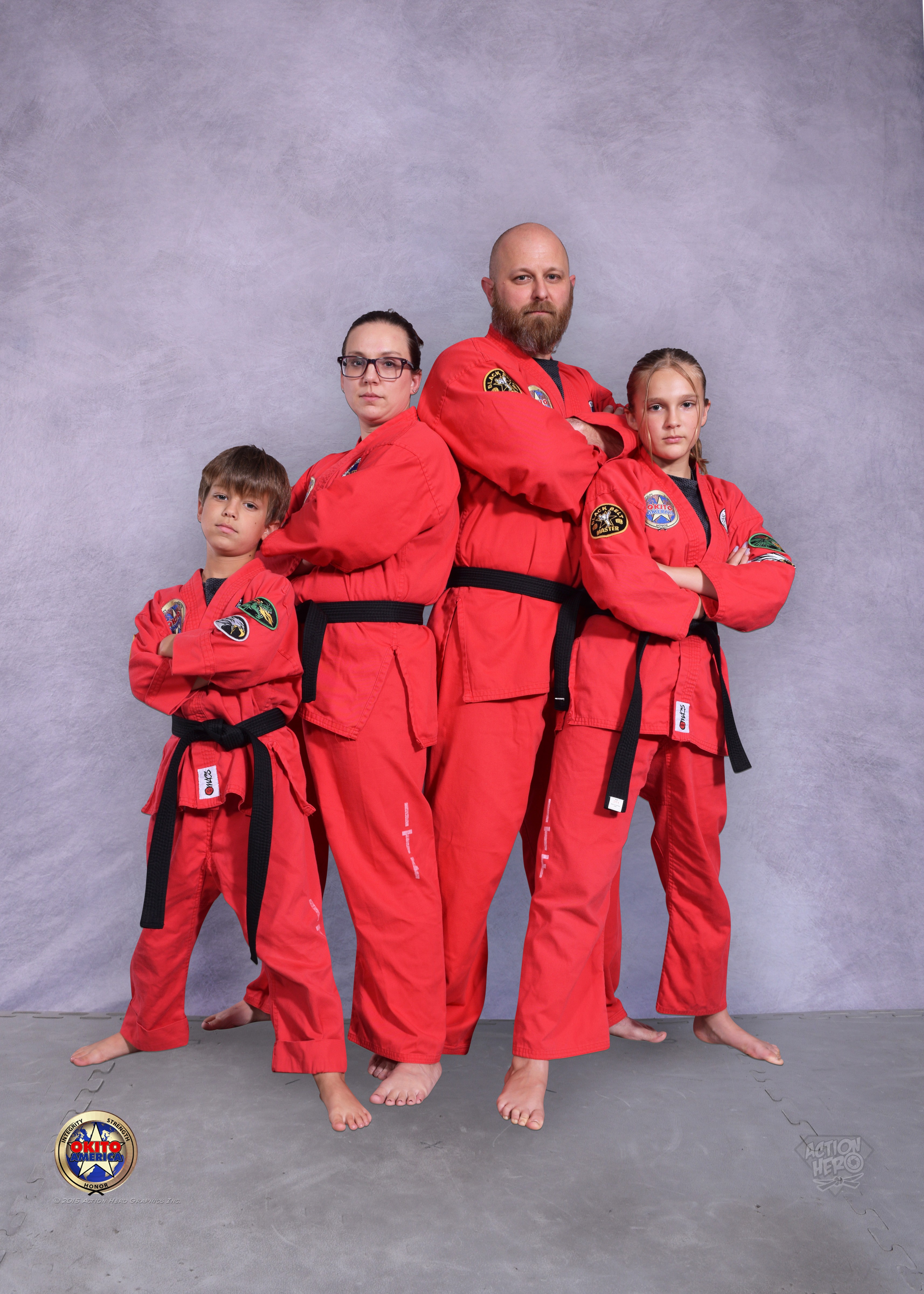 Martial Arts family posing together in their red uniforms