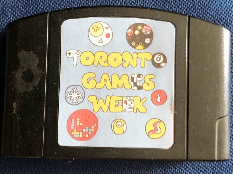 An N64 cartridge with a custom "Toronto Games Week" label.