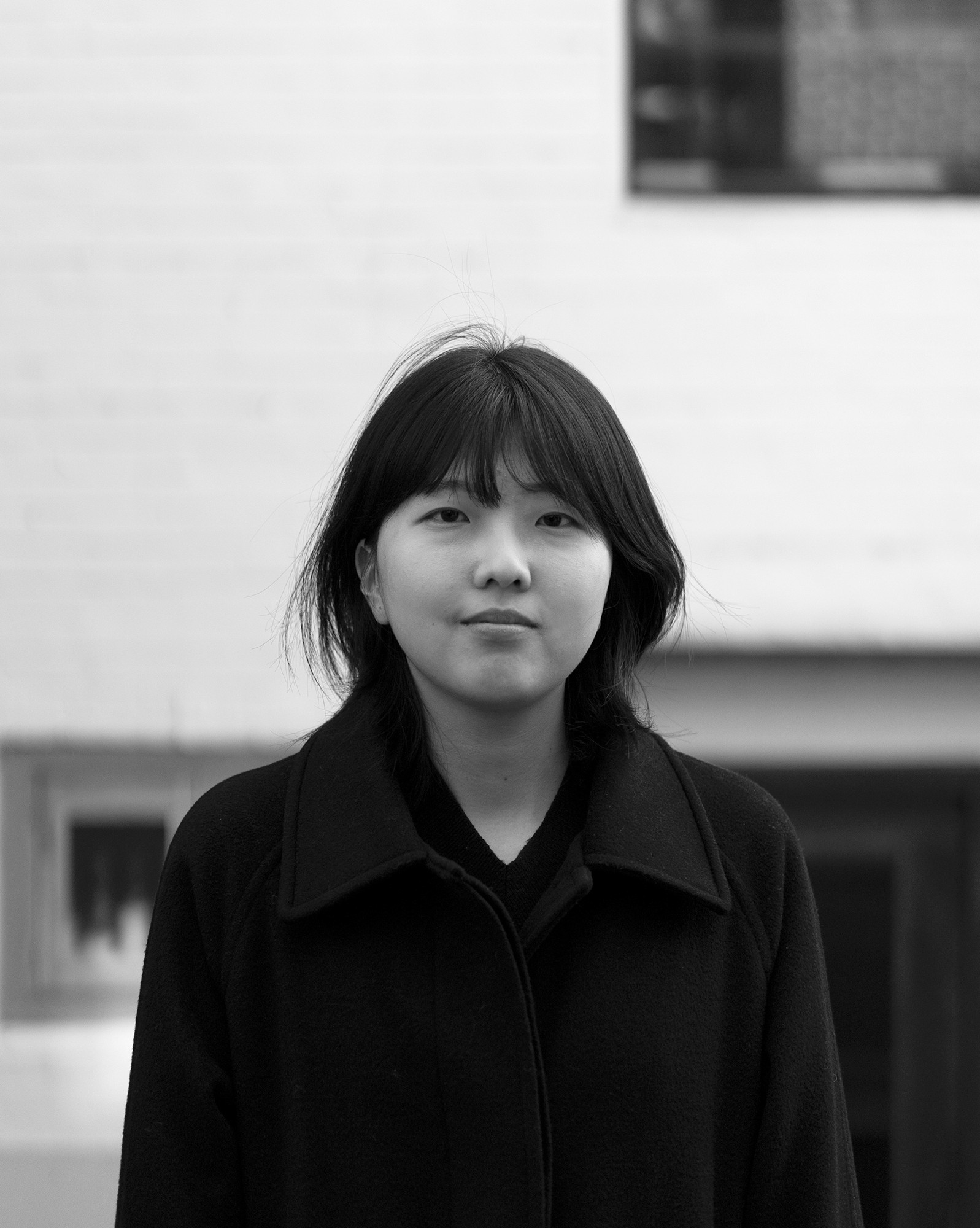 a blurry photo of a person standing in front of a wall