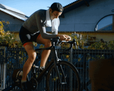 White branded cap with turquoise logo placed on fresh lemons in a red bowl