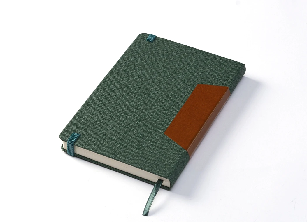 Back angled view of green notebook showing strap attachment.