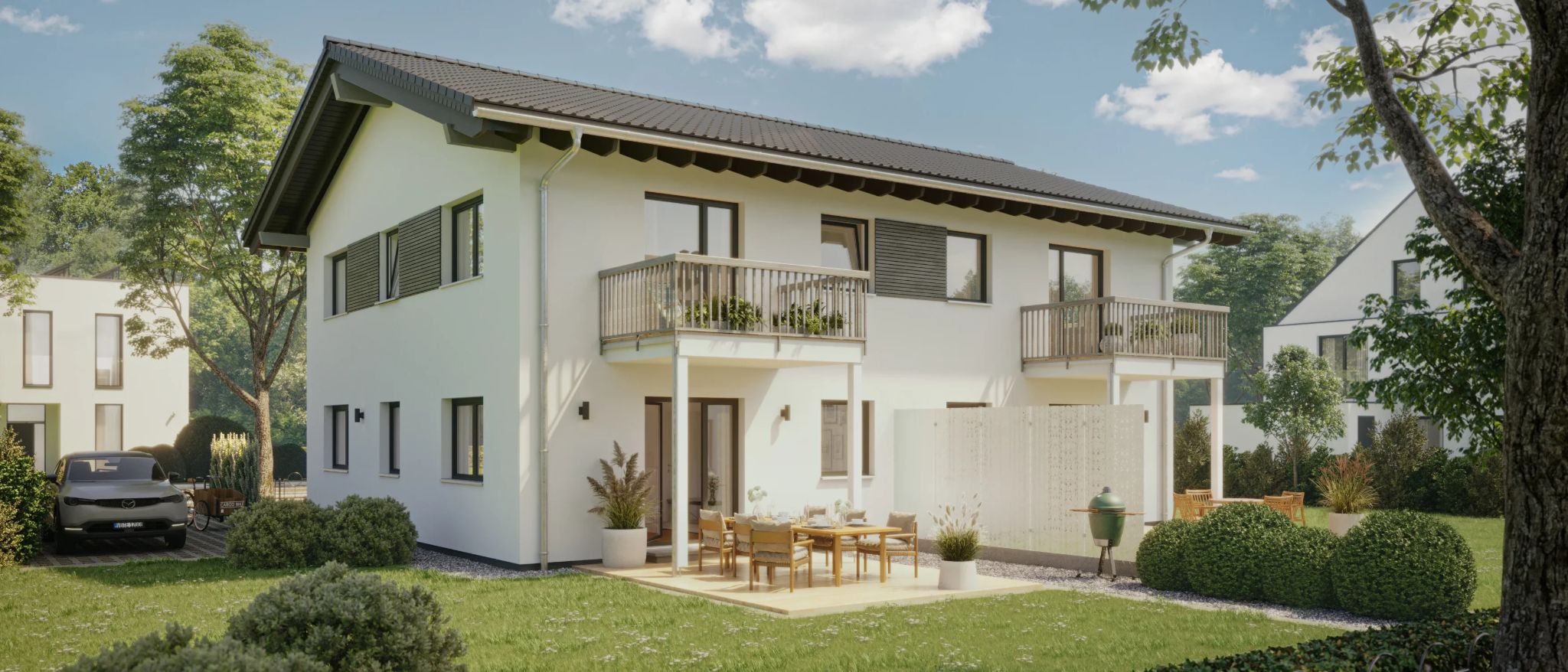 Moderne Reihenhäuser mit Balkonen, Terrasse, Essbereich im Freien und Grillplatz, umgeben von gepflegtem Grün.