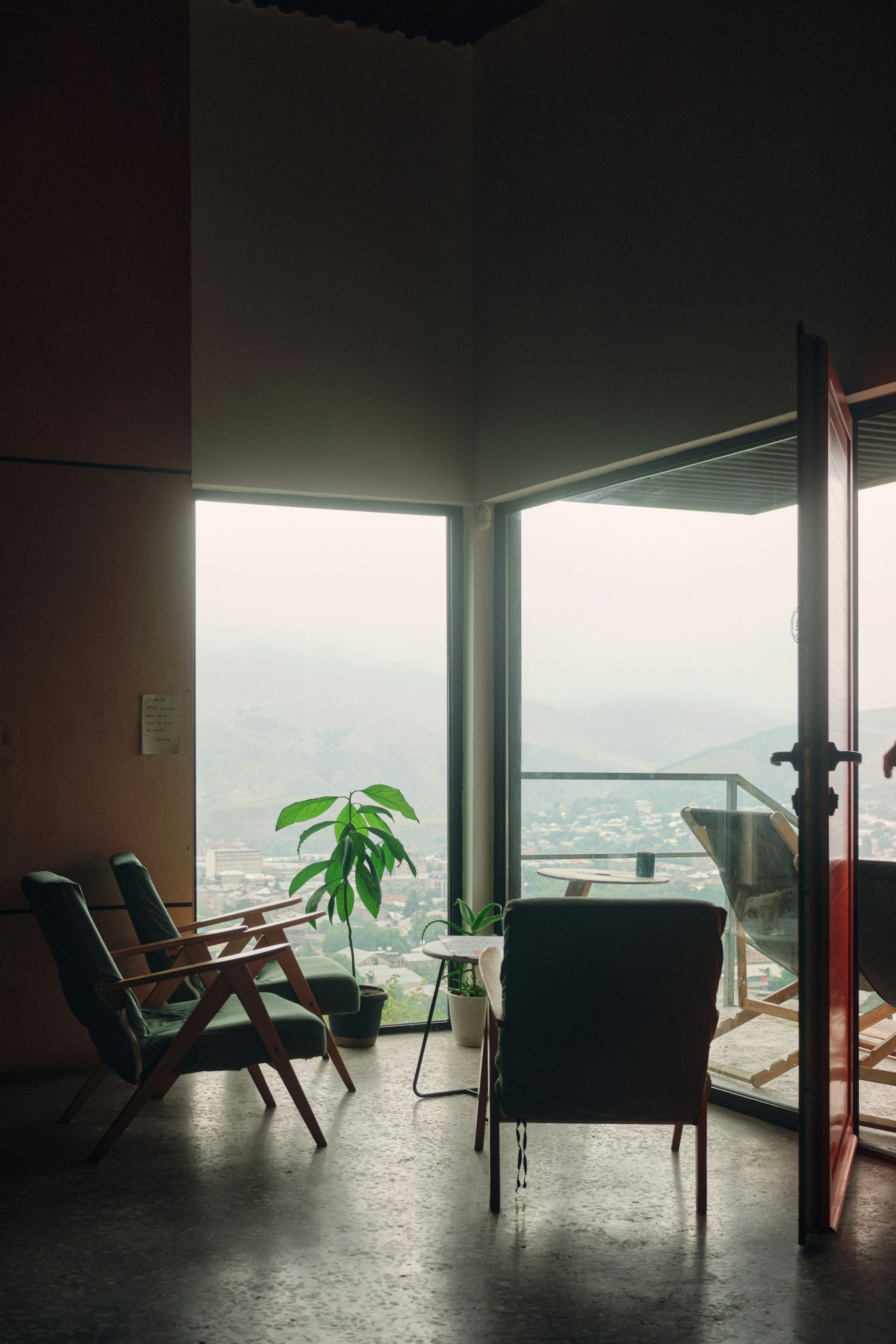 A living room filled with furniture and large windows