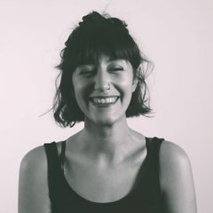 black and white portrait of a woman smiling to the camera