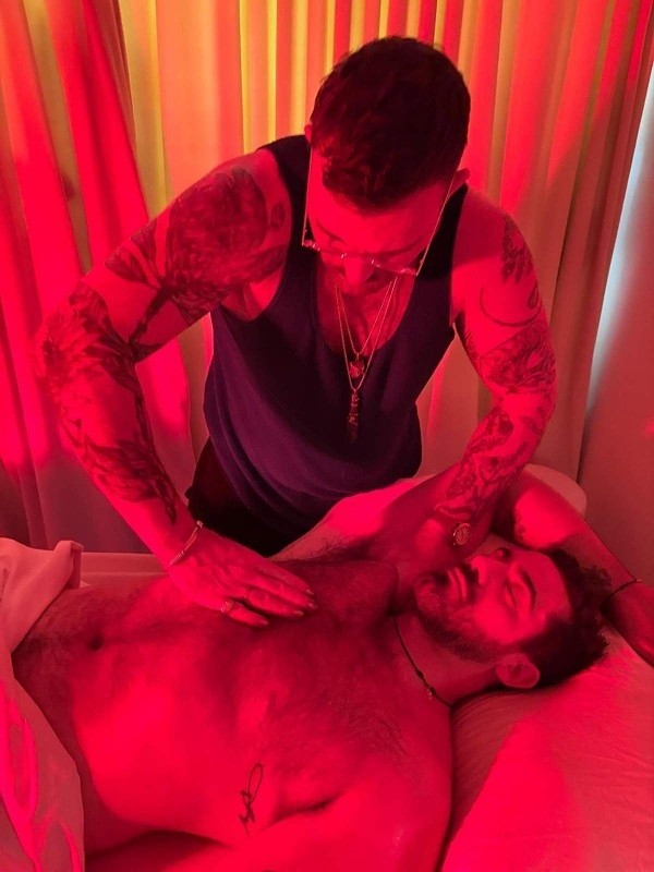 Dr. Hal giving chest massage under red ambient therapy lighting