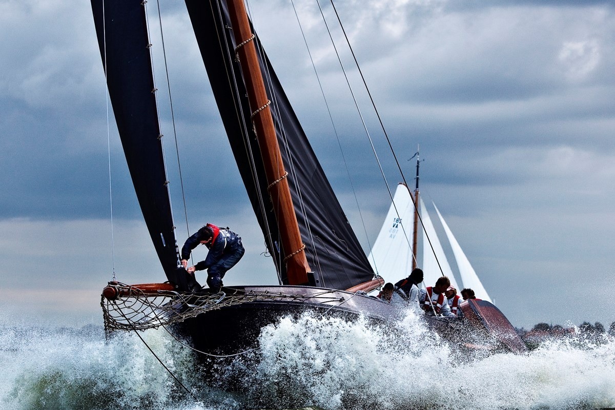 A racing sailboat heeling in a strong breeze