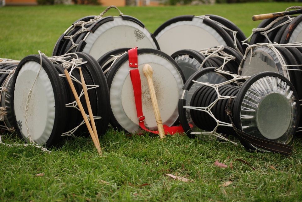 group of O7 drums laying on the grass