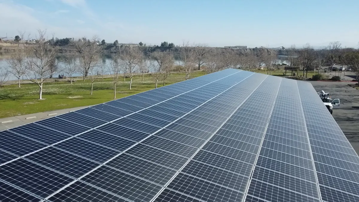 Rooftop solar array next to water and trees at Pleasanton Park in Pleasanton, CA