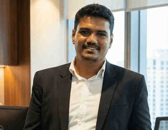 Shashidhar, client at DataviCloud, engaged in a professional workspace environment, representing AI-driven business operations.