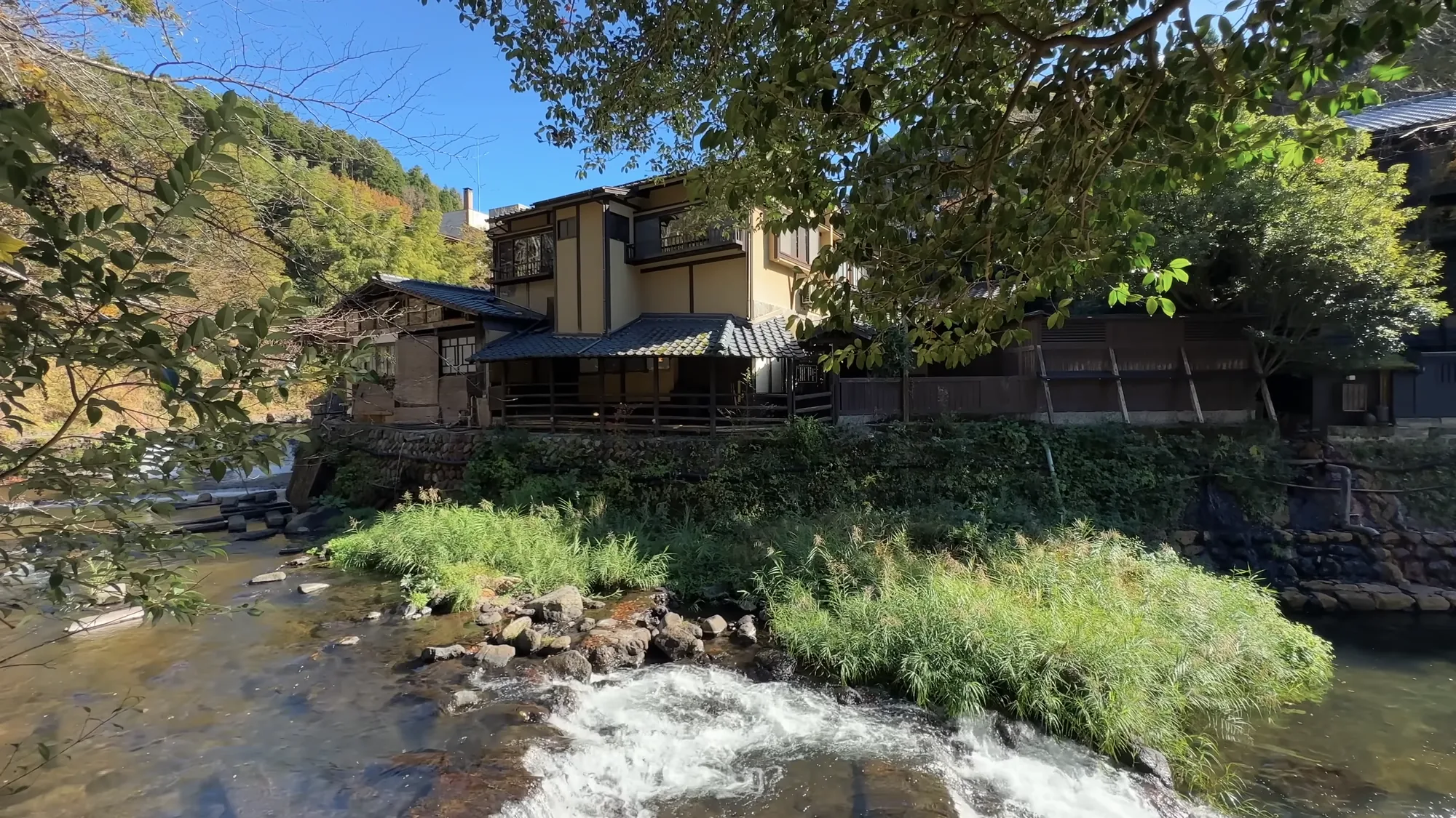 The river and inns at Kurokawa Onsen in autumn