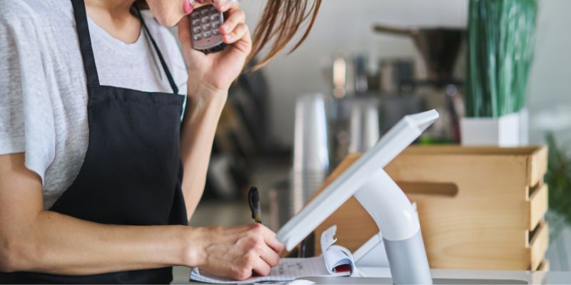 A F&B staff with a POS system