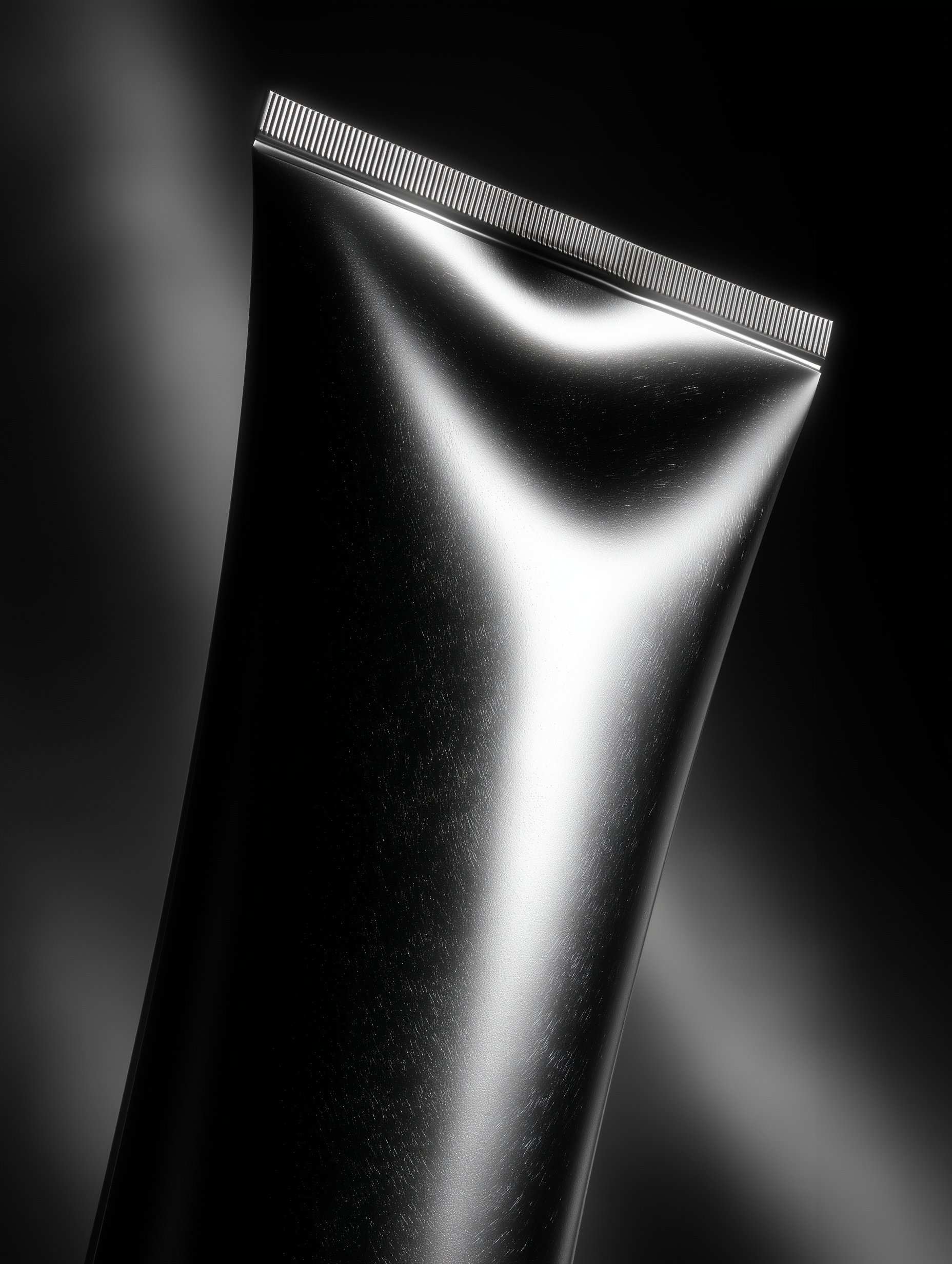 Black metallic tube tilted at angle in dramatic lighting