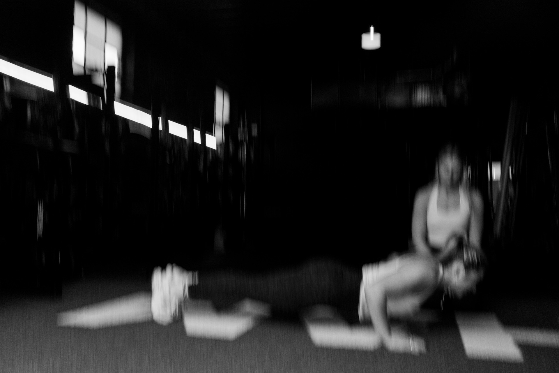 Vibey blurry image of women doing pushups at the gym