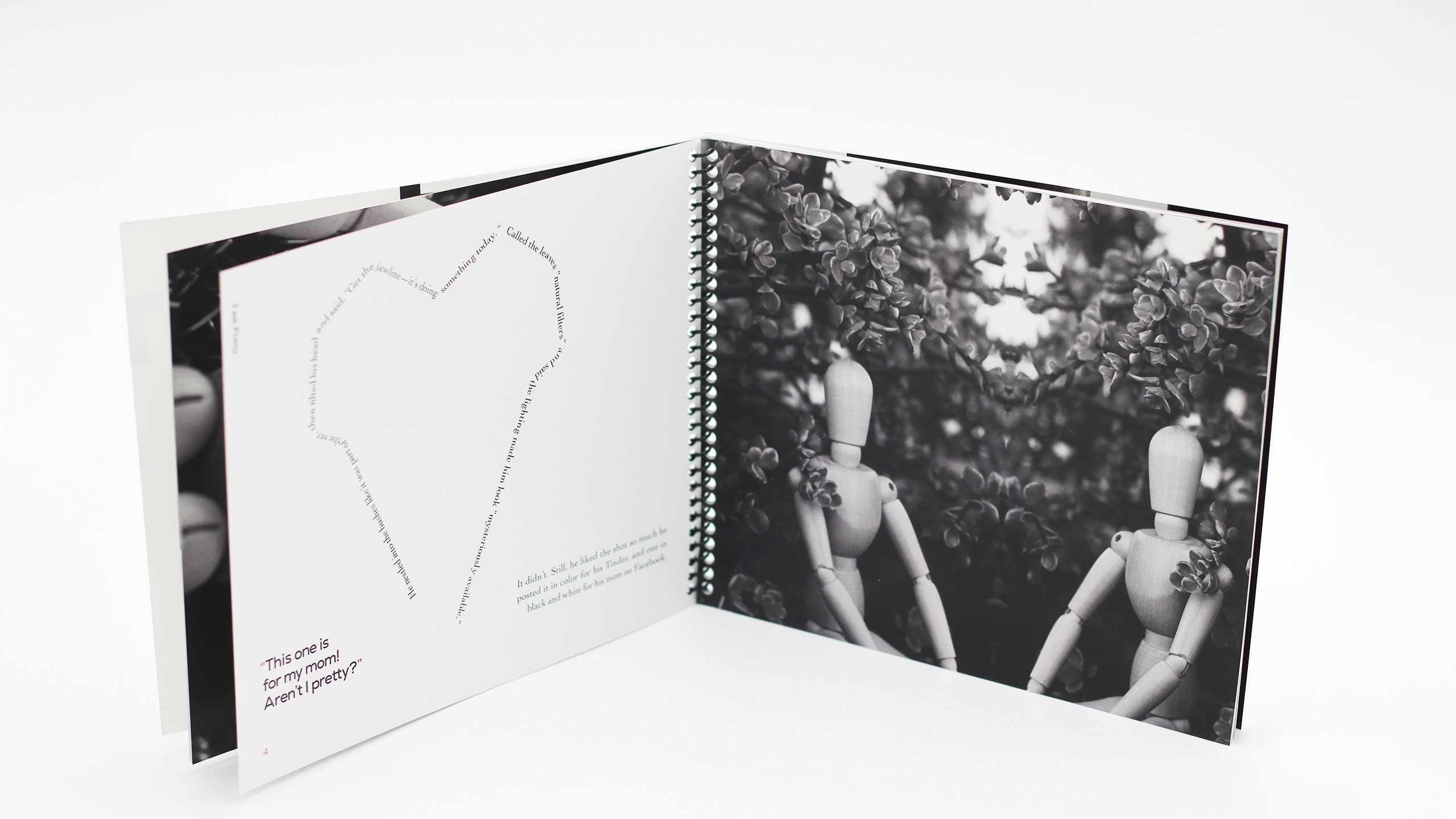 Black and white portrait photo of drawing mannequin mirrowed on one side of the spread. The other page showcases text in a form of a heart which was a shape created from the mirrored images.