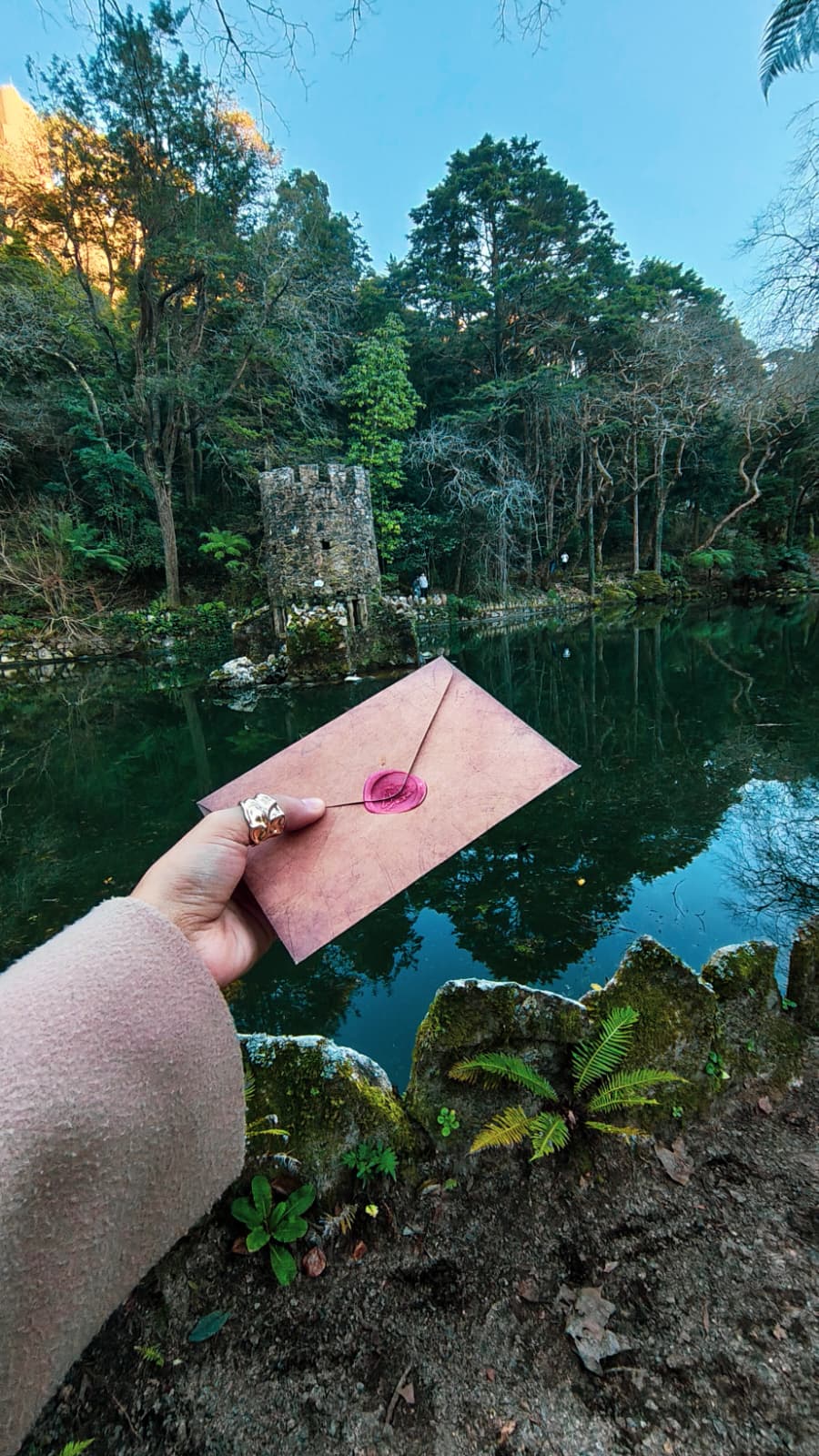 A serene spa setting with two lounge chairs beside a warm, reflective pool and soft, natural lighting.
