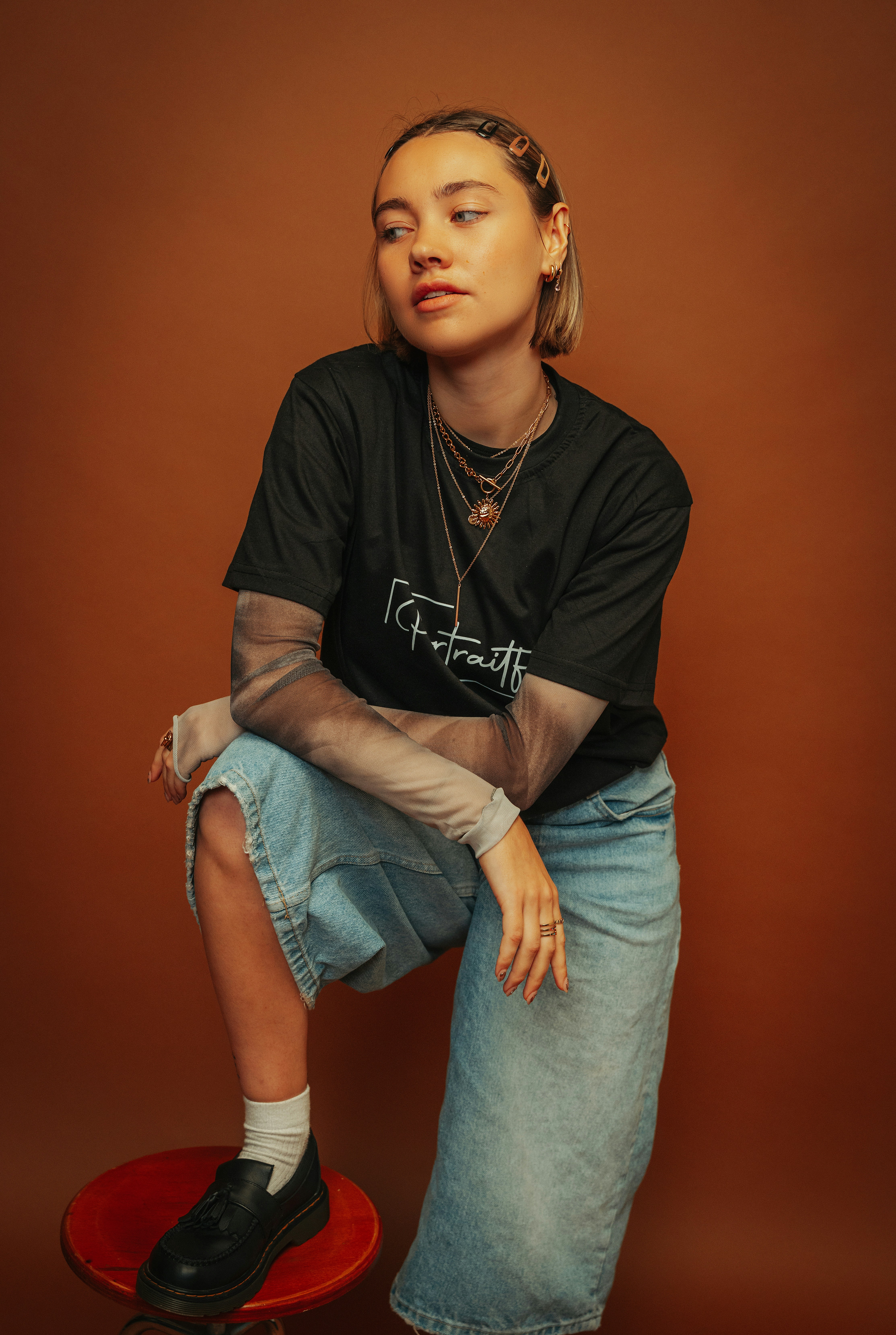 smiling woman wearing white and black pinstriped collared top