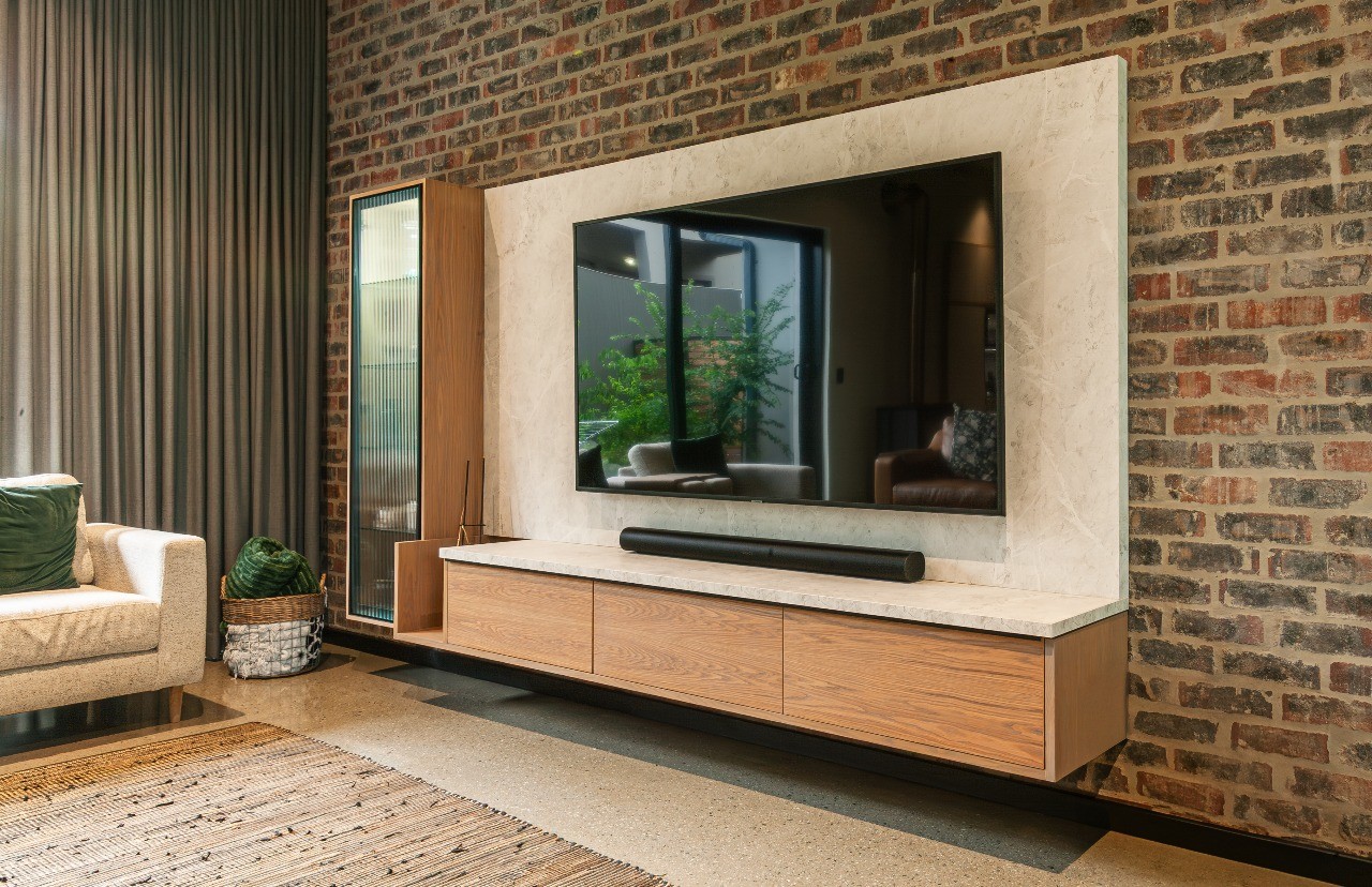 Modern interior entrance with floor-to-ceiling glass walls and warm timber cladding overlooking landscape