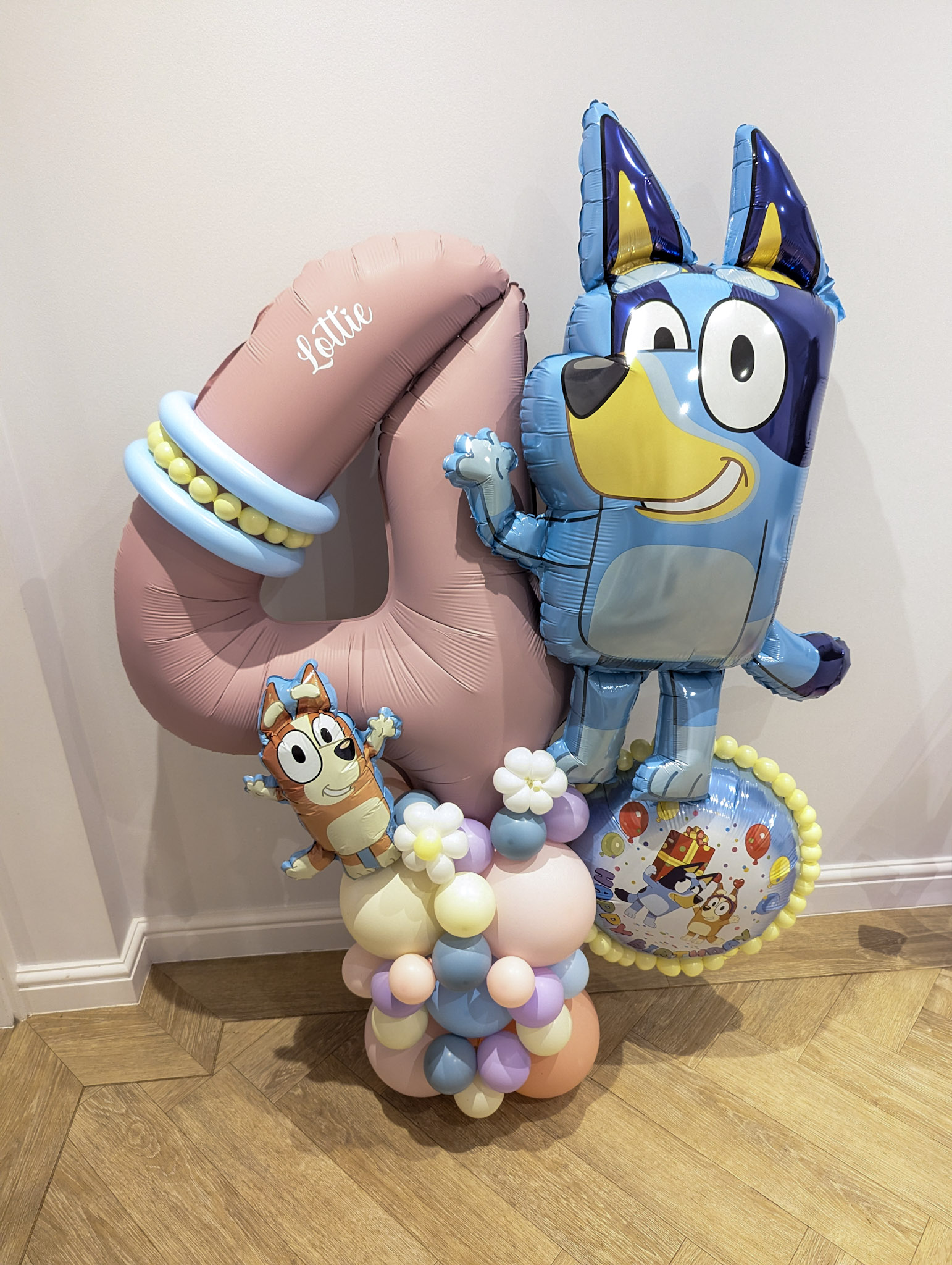 Balloon display featuring a large pink number 3 and Bluey character balloon