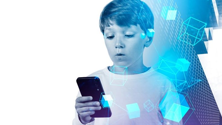 Young boy looking intently at a smartphone, surrounded by digital cube graphics and abstract blue technology elements, symbolizing children’s interaction with modern tech and online safety concerns.