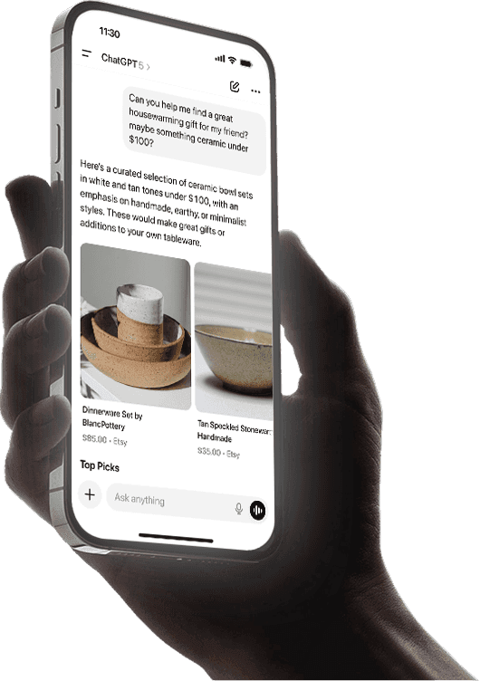 Hand holding a smartphone with a blank screen against a dark background.