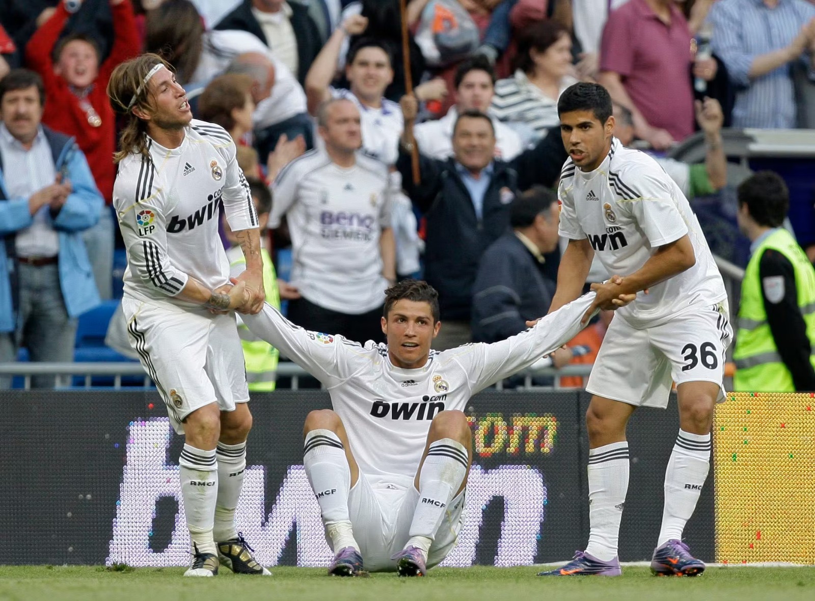 Man in red scots fc lions jersey on field.