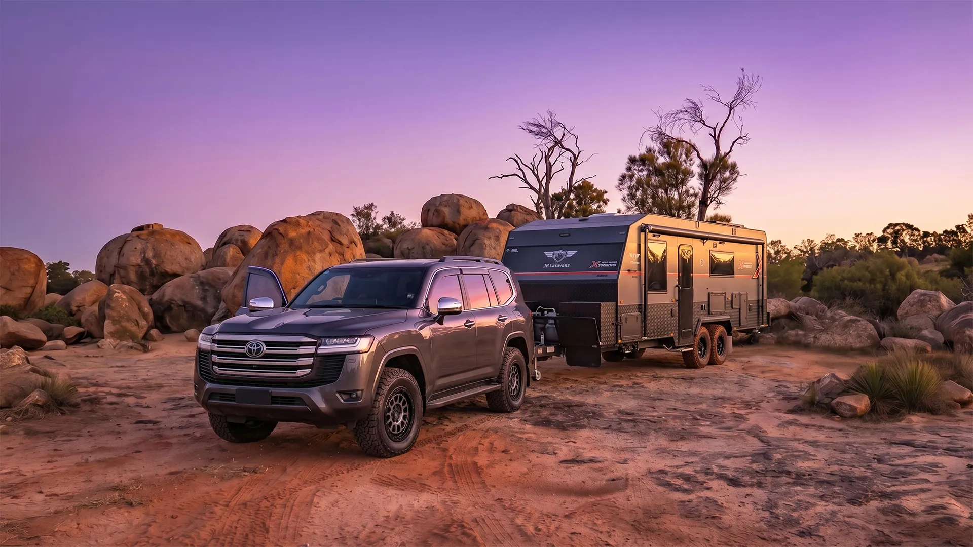 A 4WD and JB caravan together at a remote camp, late afternoon light, dust still settling behind the rig