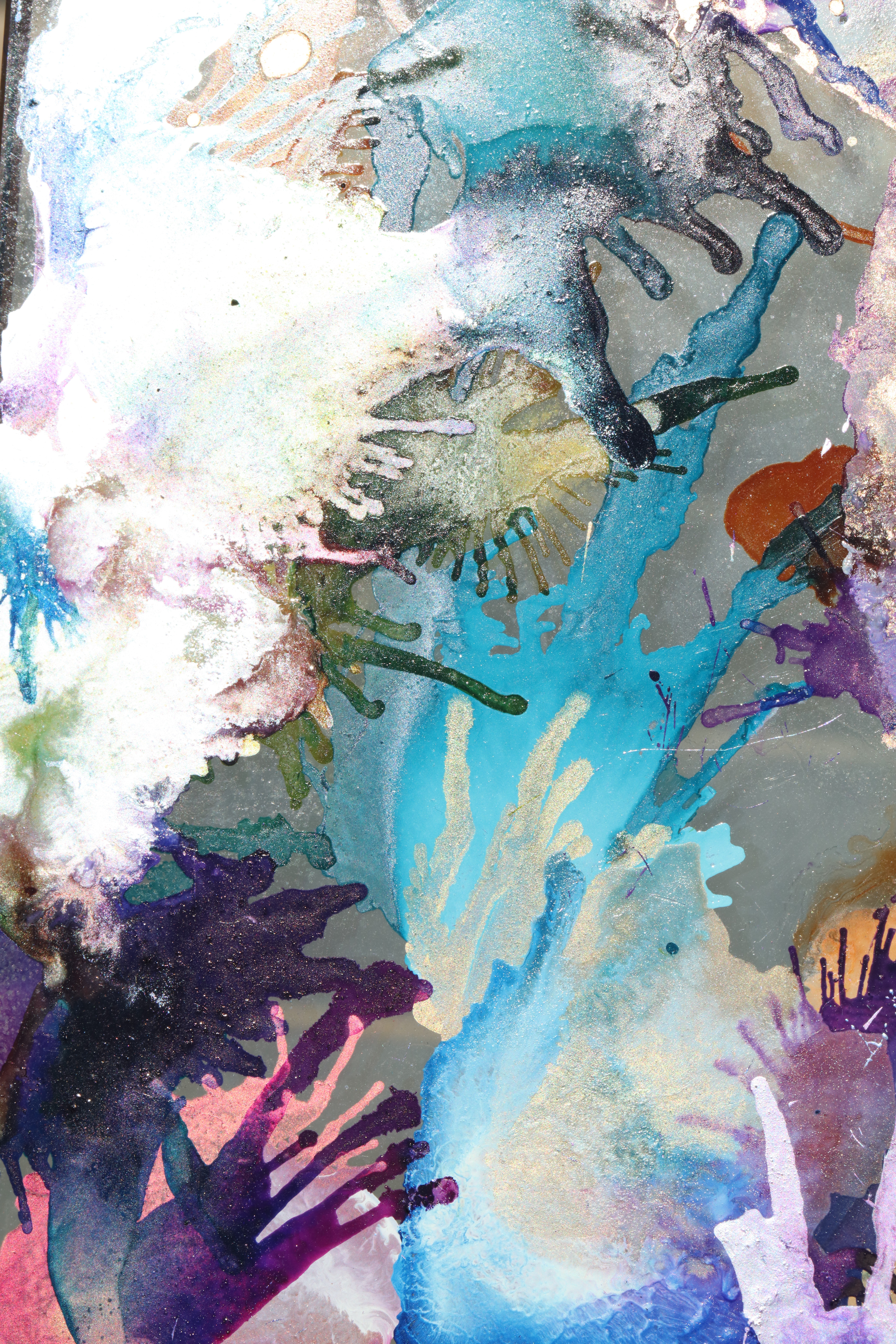 Colorful buildings reflected in rippling water, creating a distorted and painterly effect