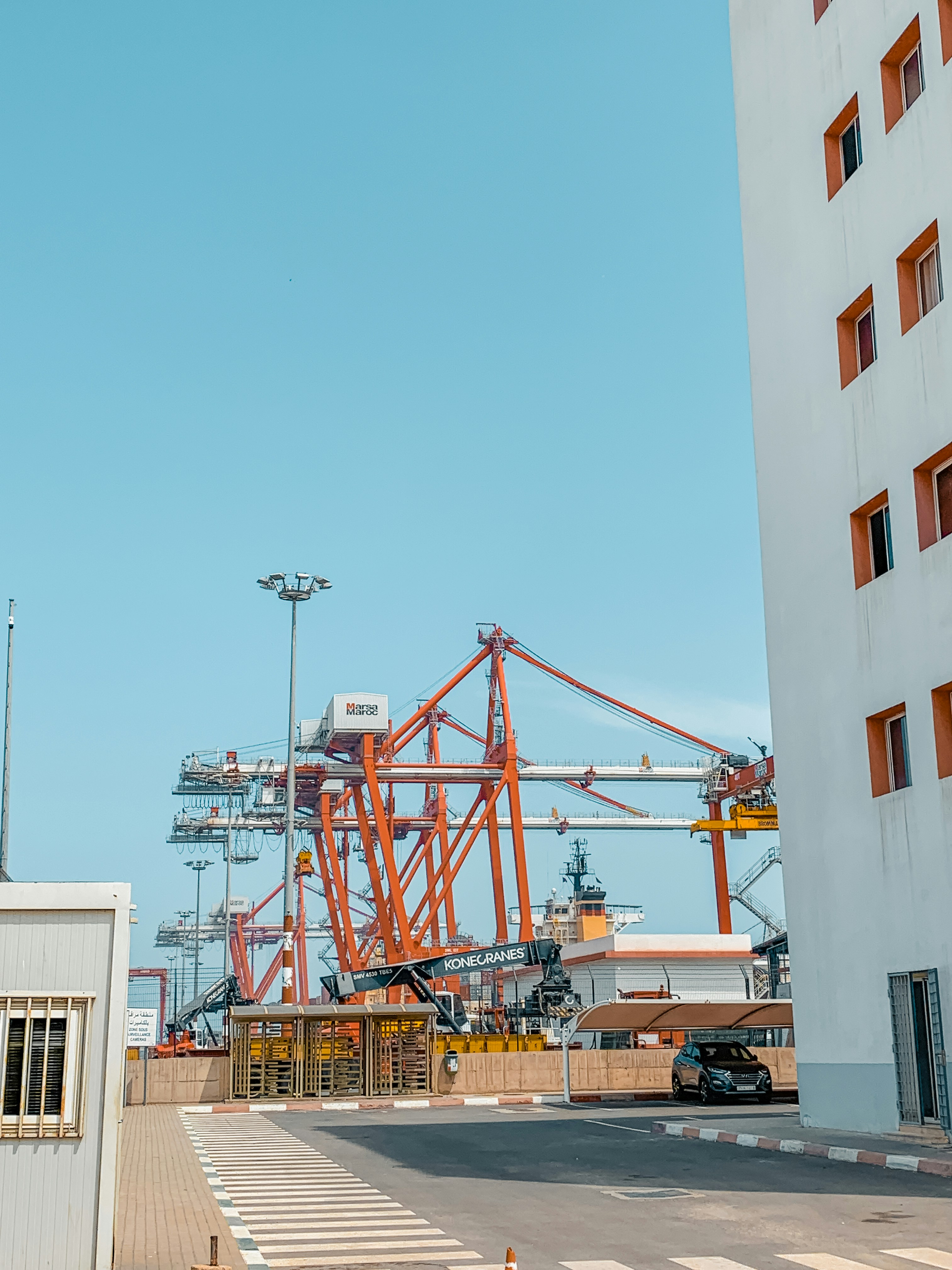 a large crane sitting next to a tall building