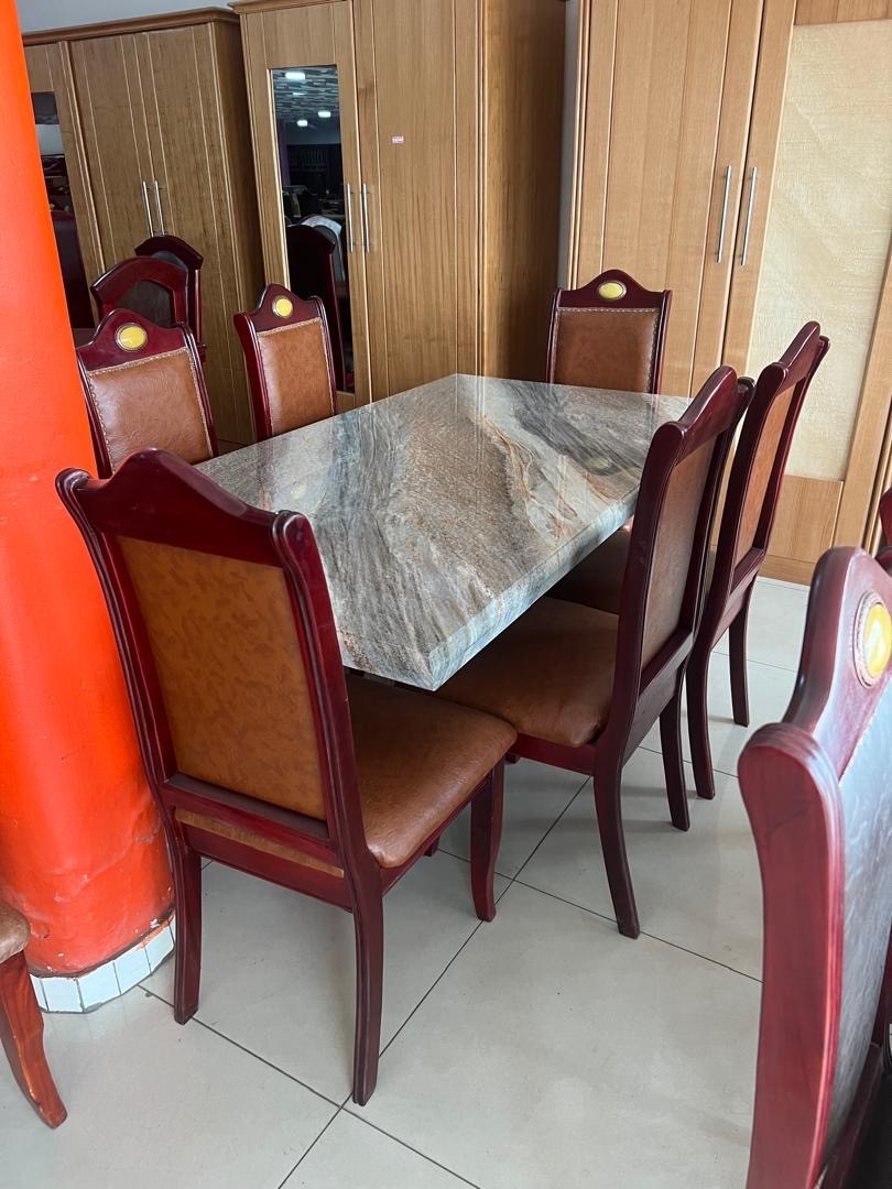 a gray couch with a wooden base on a gray background